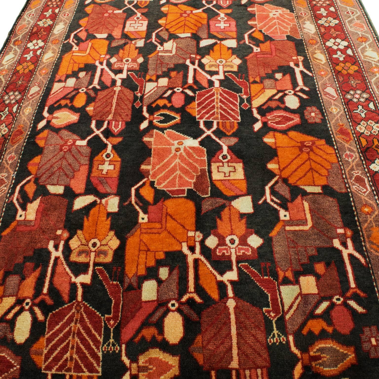 Beautiful Persian rug in a gorgeous colorway of primarily oranges, pinks and reds on black. Like new and very clean. The rug is long enough for a hallway, and large enough for an area rug. 

Rug Origin: Persian/Iran
Rug type: Bijar
Weave: