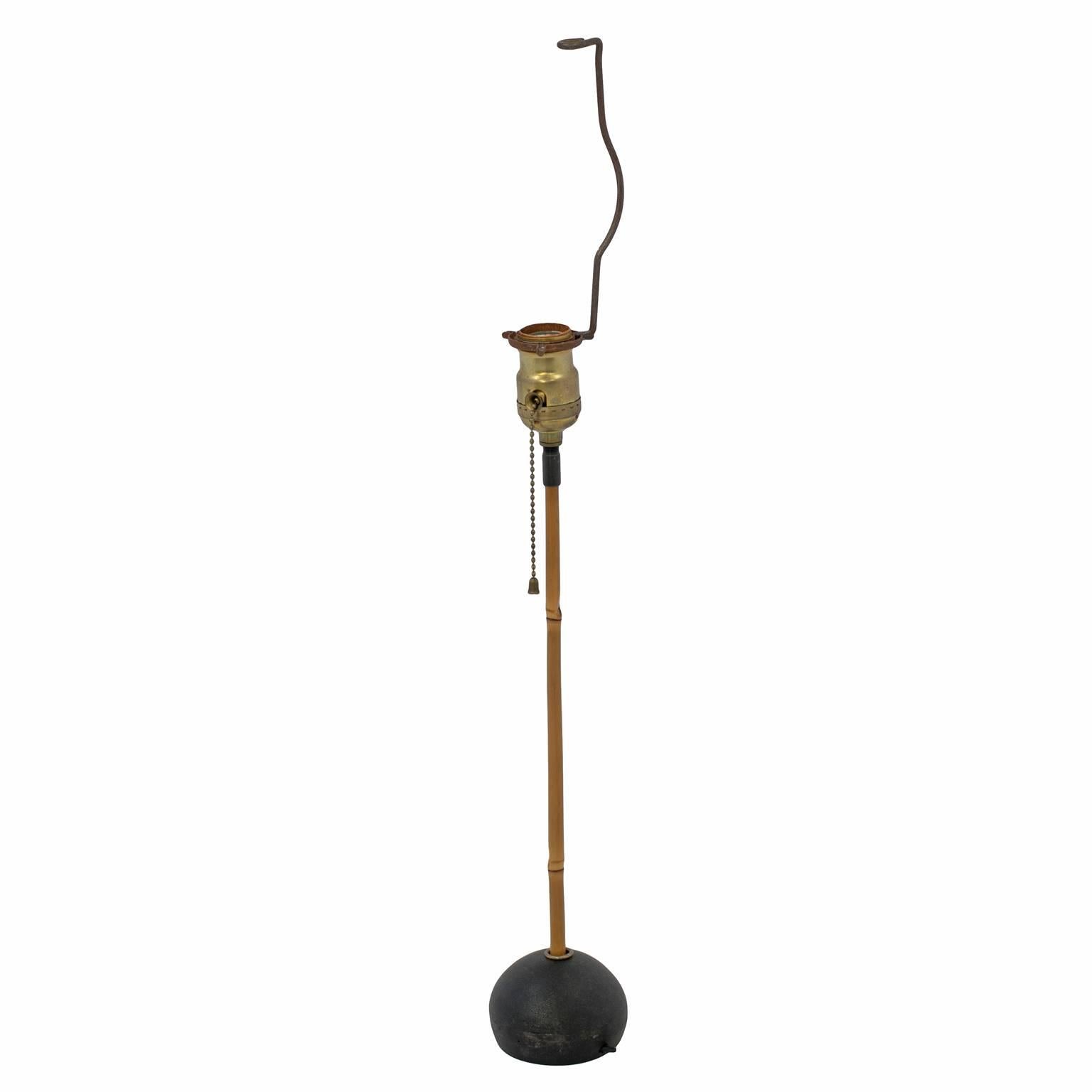 Vintage Isamu Noguchi table lamp, considered an icon of modern design. The vintage base features a bamboo pole on a black cast iron orb that is marked “Japan”. The lantern is an authentic, handmade replacement from Noguchi’s original manufacturer in
