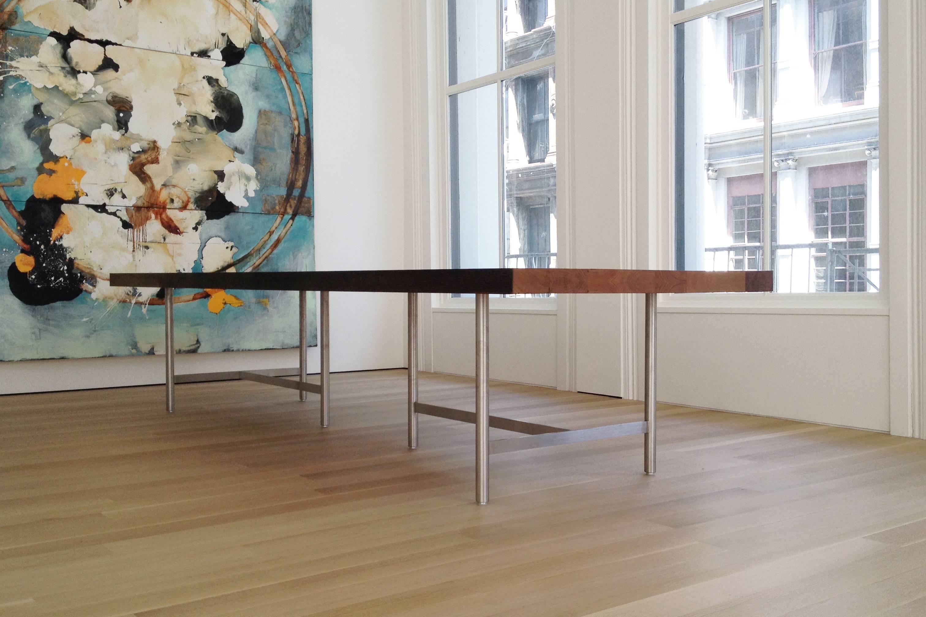 The Soho dining table considers the tension between contemporary materials. Stout reclaimed chestnut timbers provide richness and warmth; a distinct contrast to the bright, brushed stainless steel legs below. Finished with hand rubbed oil and wax