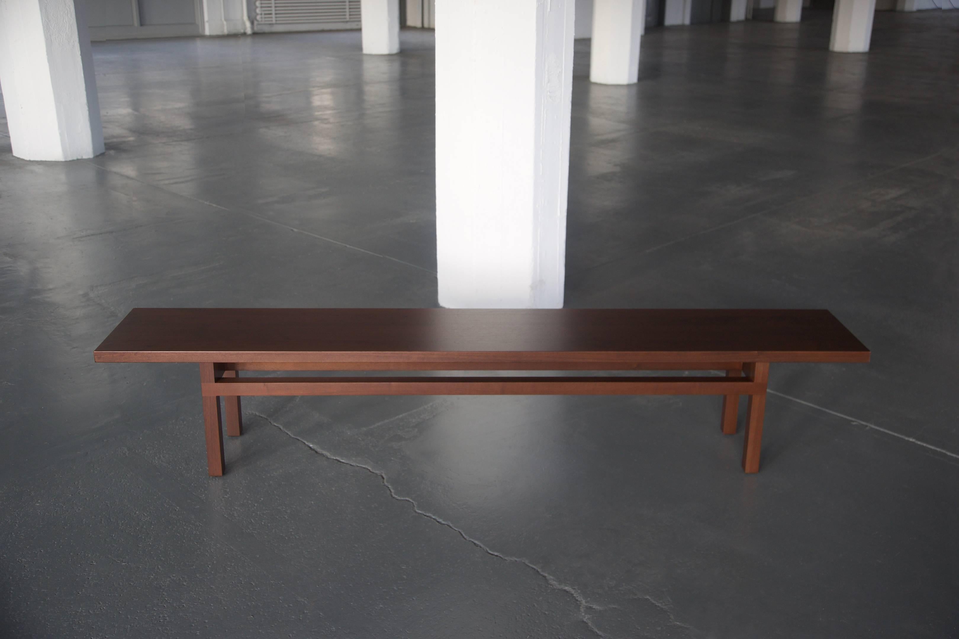 This contemporary bench is constructed of solid wood and made to order in our Brooklyn studio. Pictured in (darkened) walnut, the YARROW Bench is accented with lap joint aprons and enlists group of slender timbers to visually elongate the