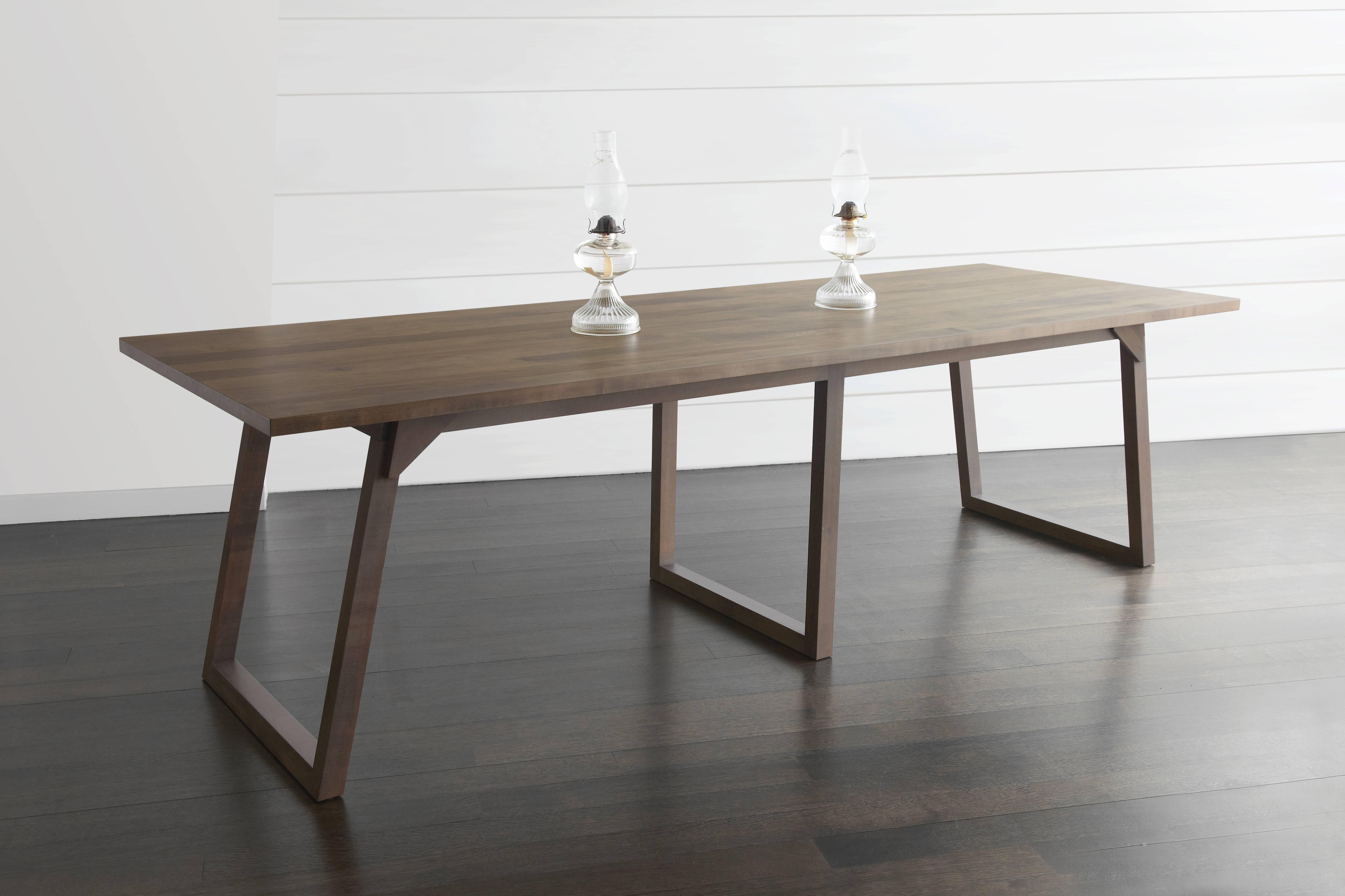 With joined legs and triangular accents akin to the traditional folding table, 
The Familj dining table celebrates large family gatherings. Angled legs are accented with pronounced lap joints. The slender top and the warmth of the oxidized