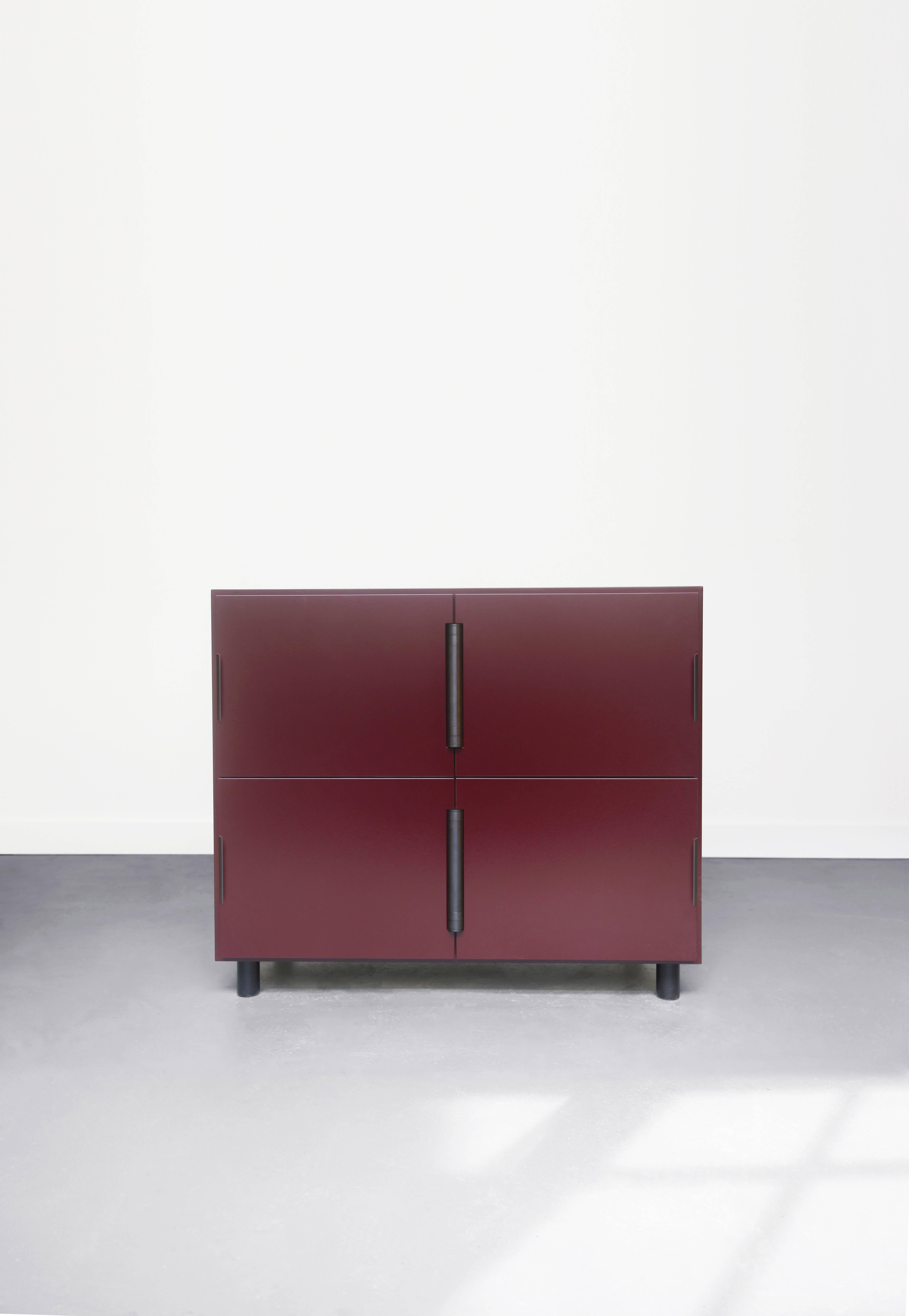 Nocturne is a multi-use storage cabinet with an austere beauty. Its center-hung doors swing inward on a shared hinge. The modern case is matte lacquered wood with sophisticated blackened steel hardware. 

Available finishes: 
Oxblood and