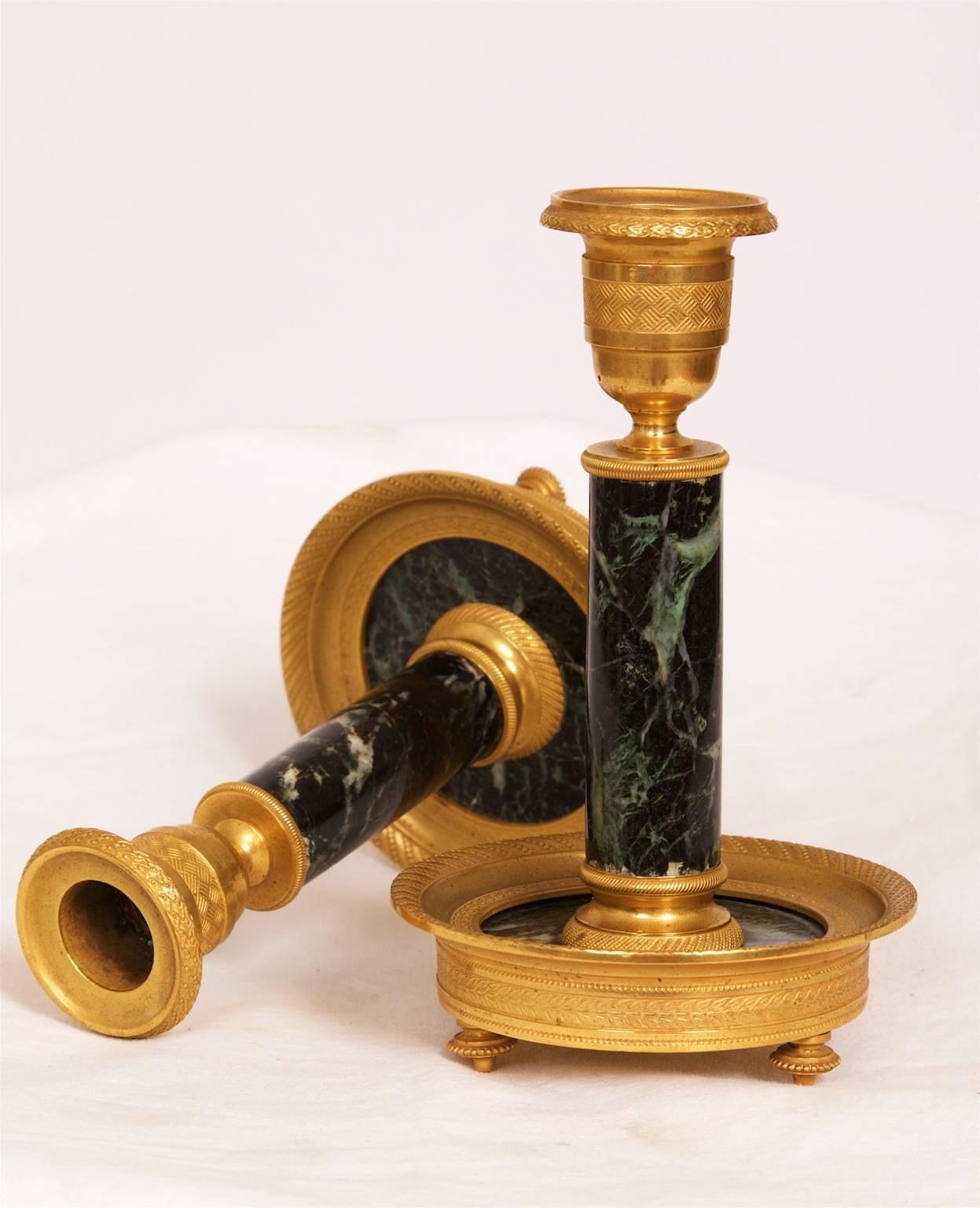 A pair of elegant gilt brass and marble candlesticks, circa 1880, France.