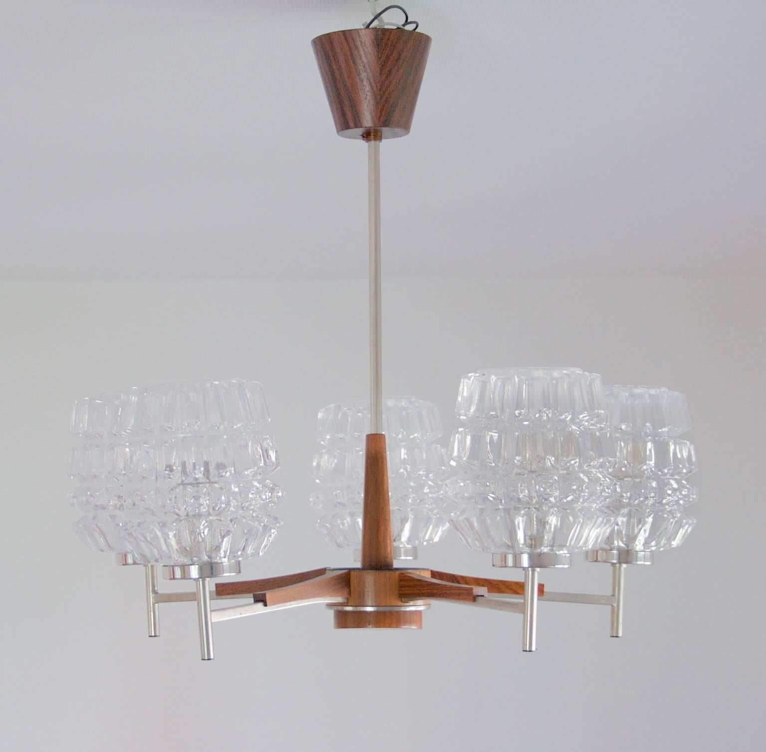 A very cool, nice and slim Pendant, 1960s-1970s, Swedish, teak, glass and chromed steel. The pendant can be fitted with another model of a lamp glass to get a more alternative look. Five glasses. It can easily be fitted with a plug for US standards