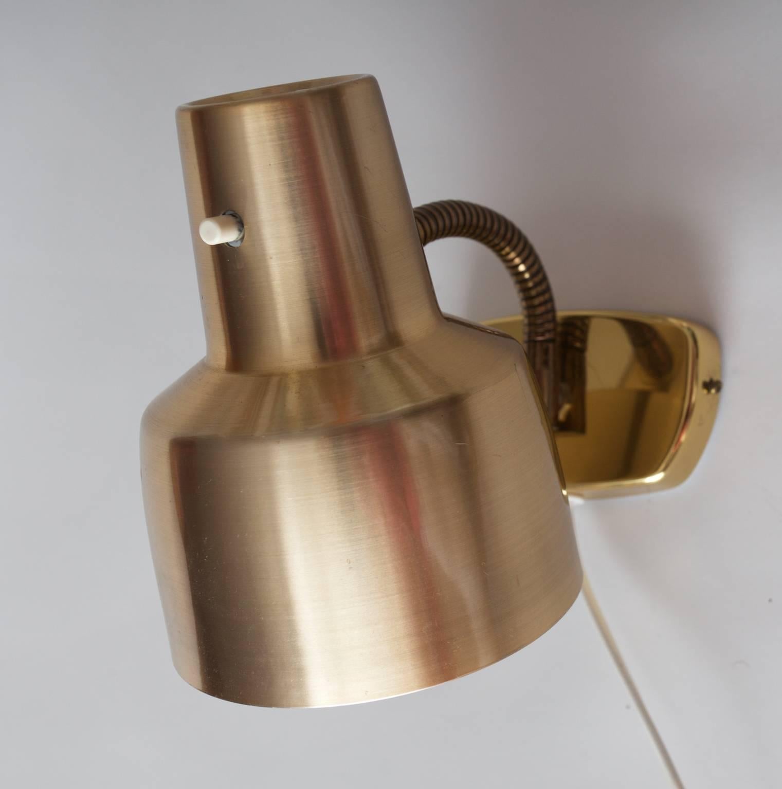 Wall lamp in brass and anodized aluminium, Sweden, 1960s from Armaturhantverk in Tibro Sweden.

The wall fitting is made of brass and the lampshade is made of aluminium.

The company was founded in 1945 and is still active as a manufacturer of