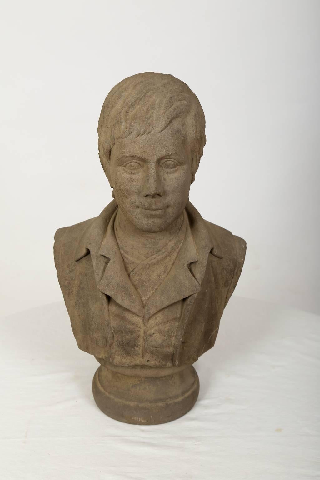 A stone (granite) bust of the Scottish author Robert Burns. The bust might be made after the best known portrait of the author painted by Alexander Nasmyth in 1787. 

"Robert Burns (25 January 1759 – 21 July 1796), also known as Rabbie Burns,