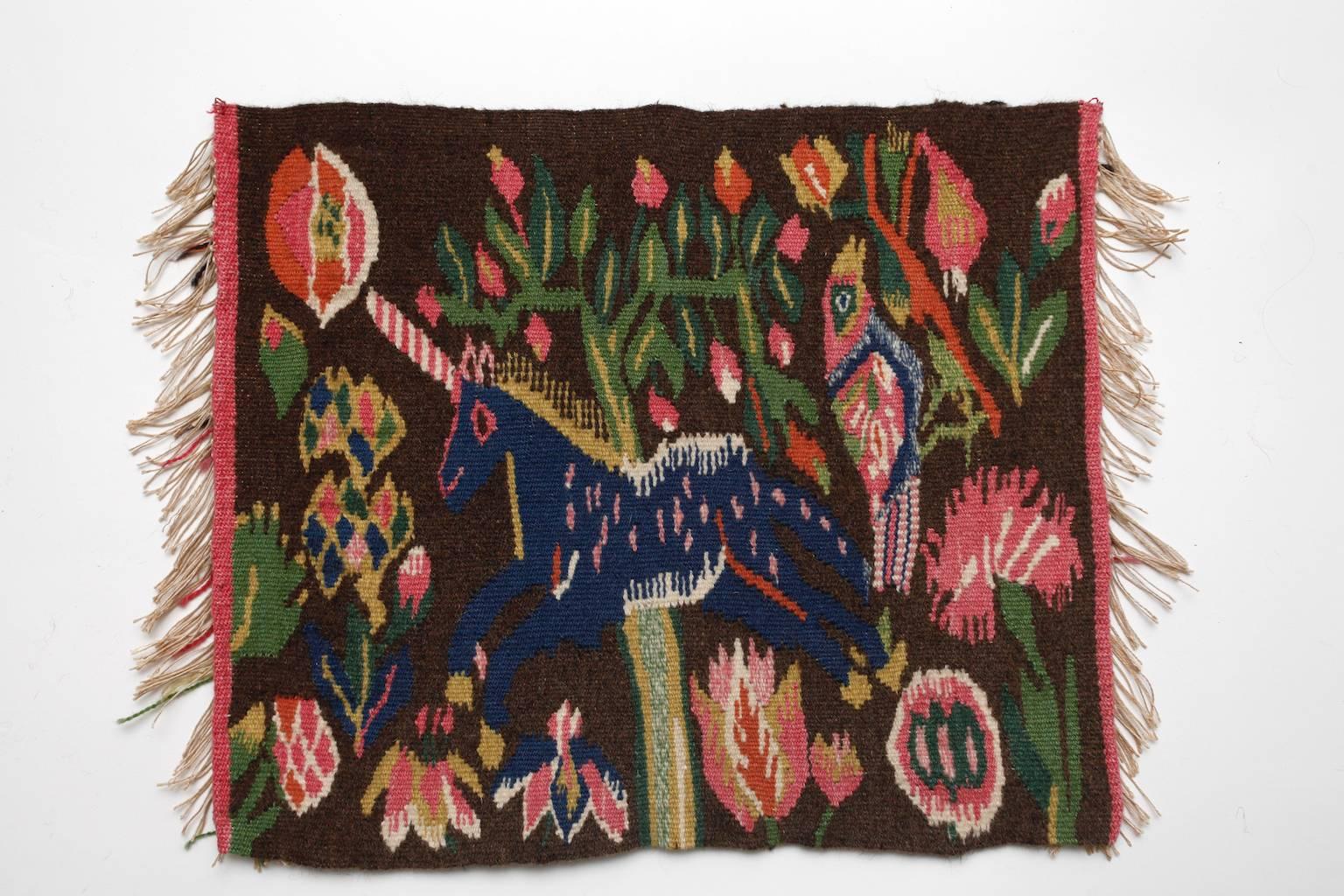 A beautiful small handwoven Swedish wool and linen tapestry from the province Skåne in south of Sweden. probably made during the late 19th or early 20th century.
The main motif is a unicorn in a garden with flowers like Tulips, carnations, etc and