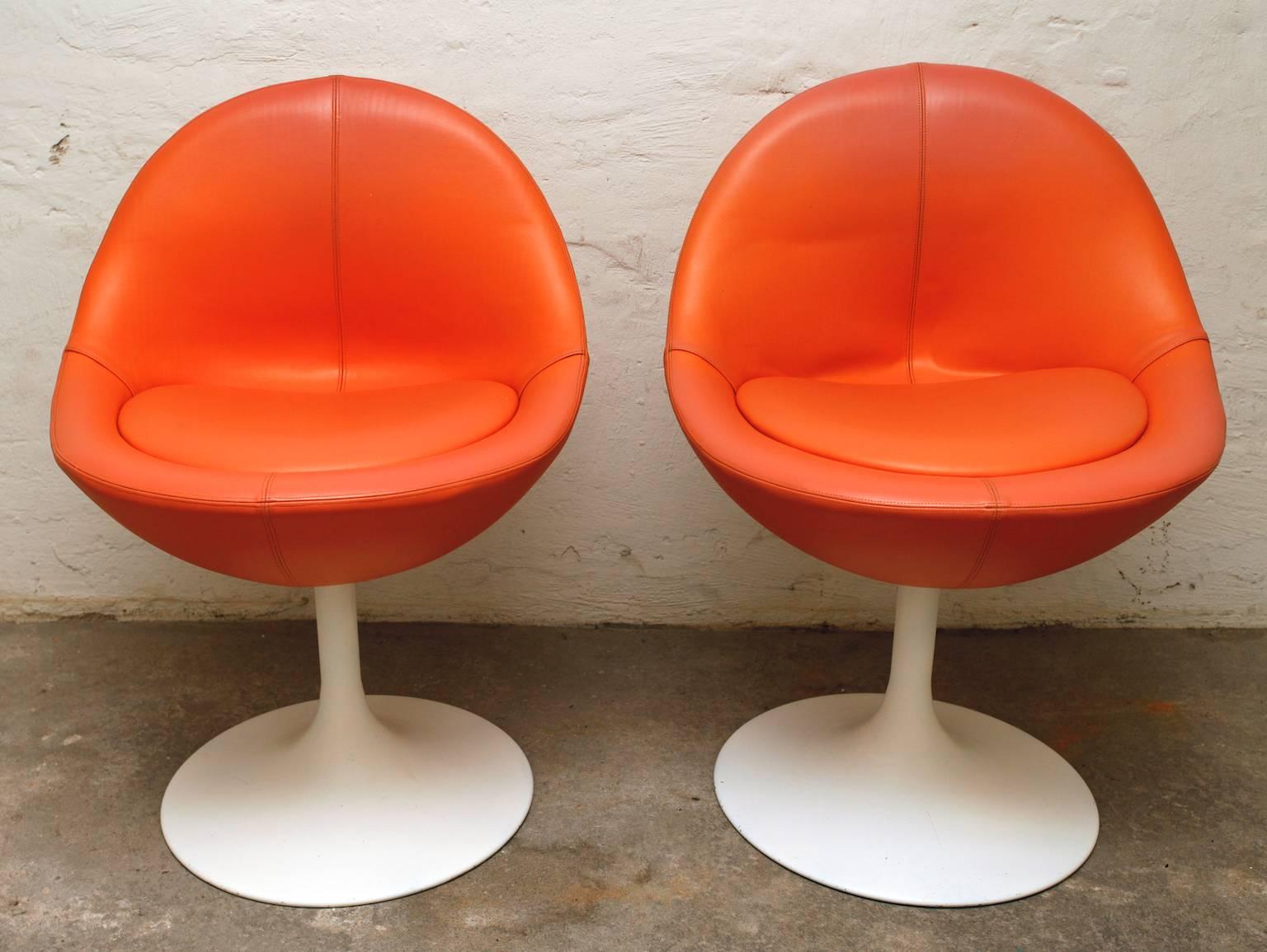 Two very cool orange Venus swivel chairs on white tulip foot by Johanson Design, Sweden, 1960-1970s. 
This epitomizes Swedish hip design of the 1960s and 1970s.
The chairs where designed by Börje Johanson Design in Markaryd, Sweden. Johanson