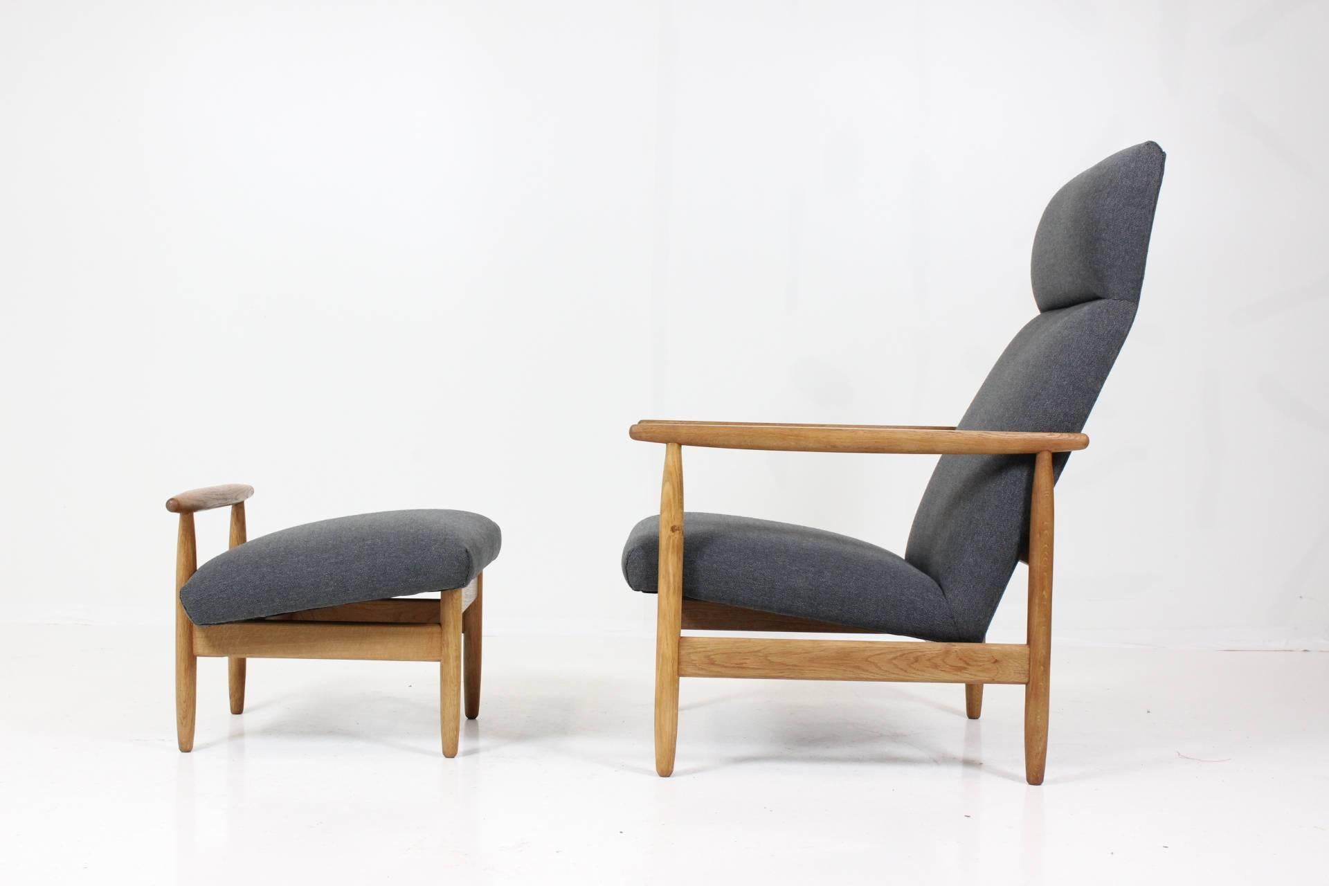 High back oak armchair by E.A. Johansson for FDB Møbler, Model J-65. The chair and stool were carefully restored and newly upholstered with quality soft fabric in grey color.