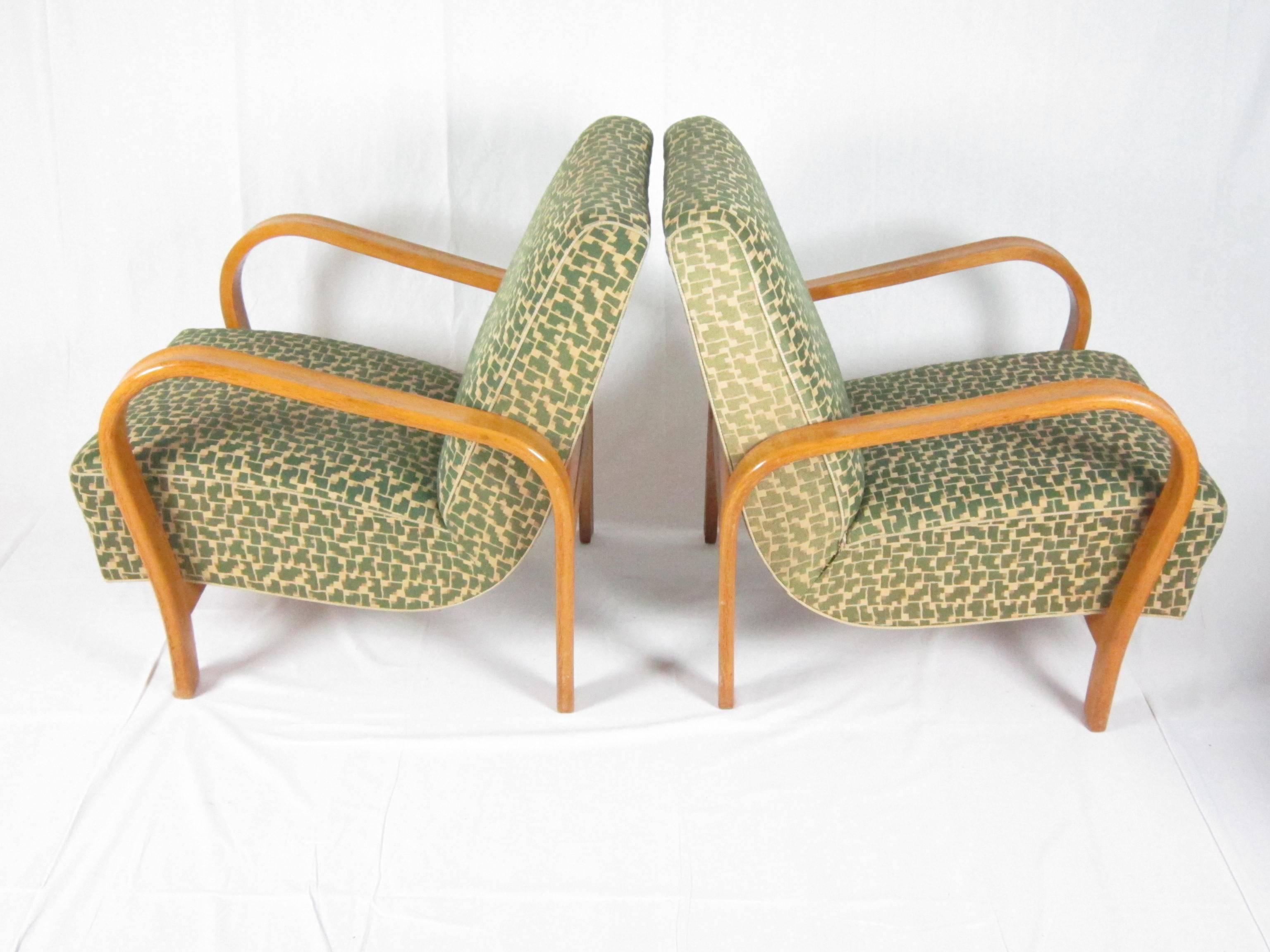 This Art Deco armchairs by Jindrich Halabala were made in Czechoslovakia, circa 1940. The armchairs are in good original condition included fabric upholstery. The frame is from beech bentwood.