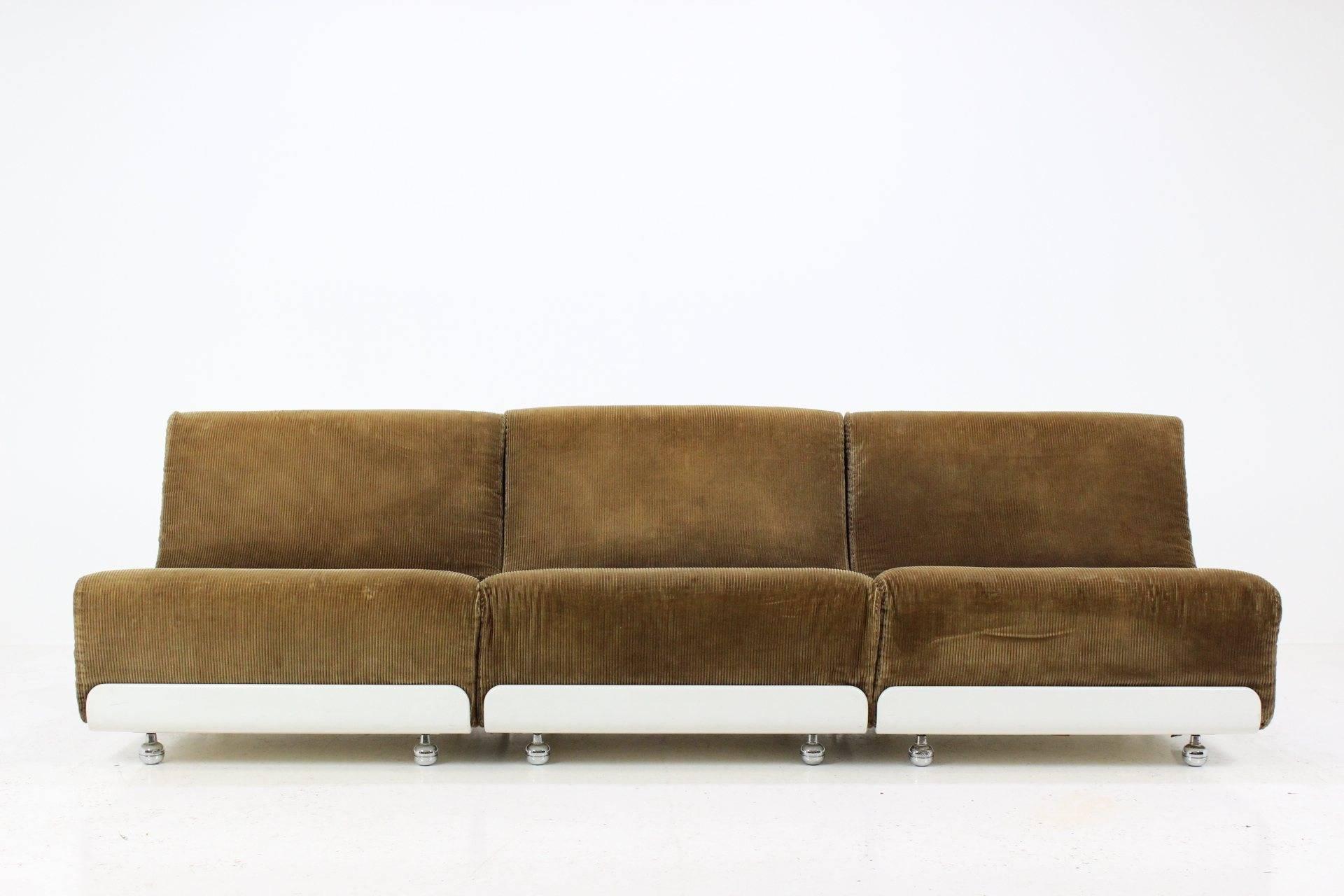This set of three vintage sofa units was designed by Luigi Colani, and manufactured in Germany by COR. Each unit features a white base with metal wheels, and brown fabric upholstery seat and backrest. The units can be used individually or put