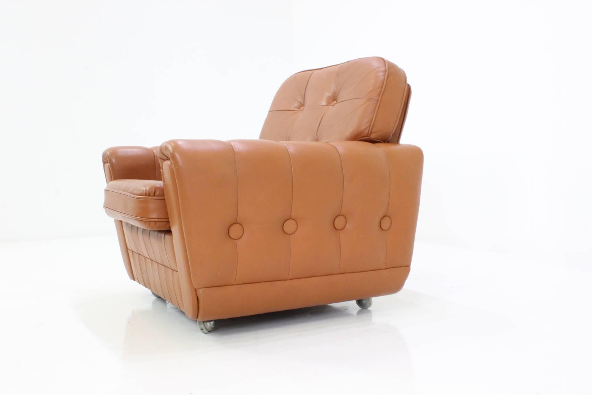 Comfortable leather Mid-Century brown armchair.