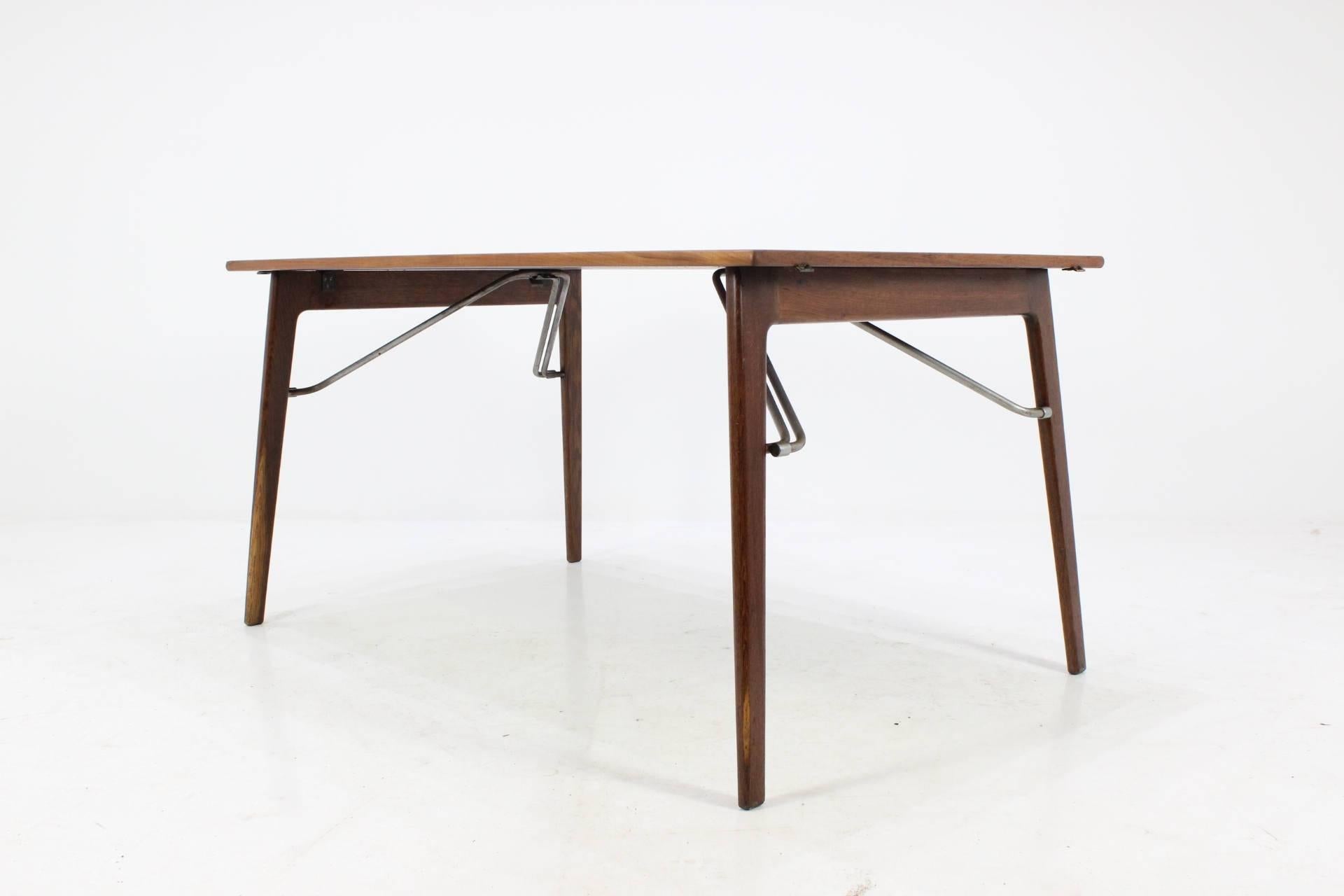 Leaf teak dining table by Børge Mogensen for Søborg Møbelfabrik. Rarely did Mogensen use steel as a featured material for his designs but with this particular piece, we see it used in the drop leaf supports. A desk and another variation of this