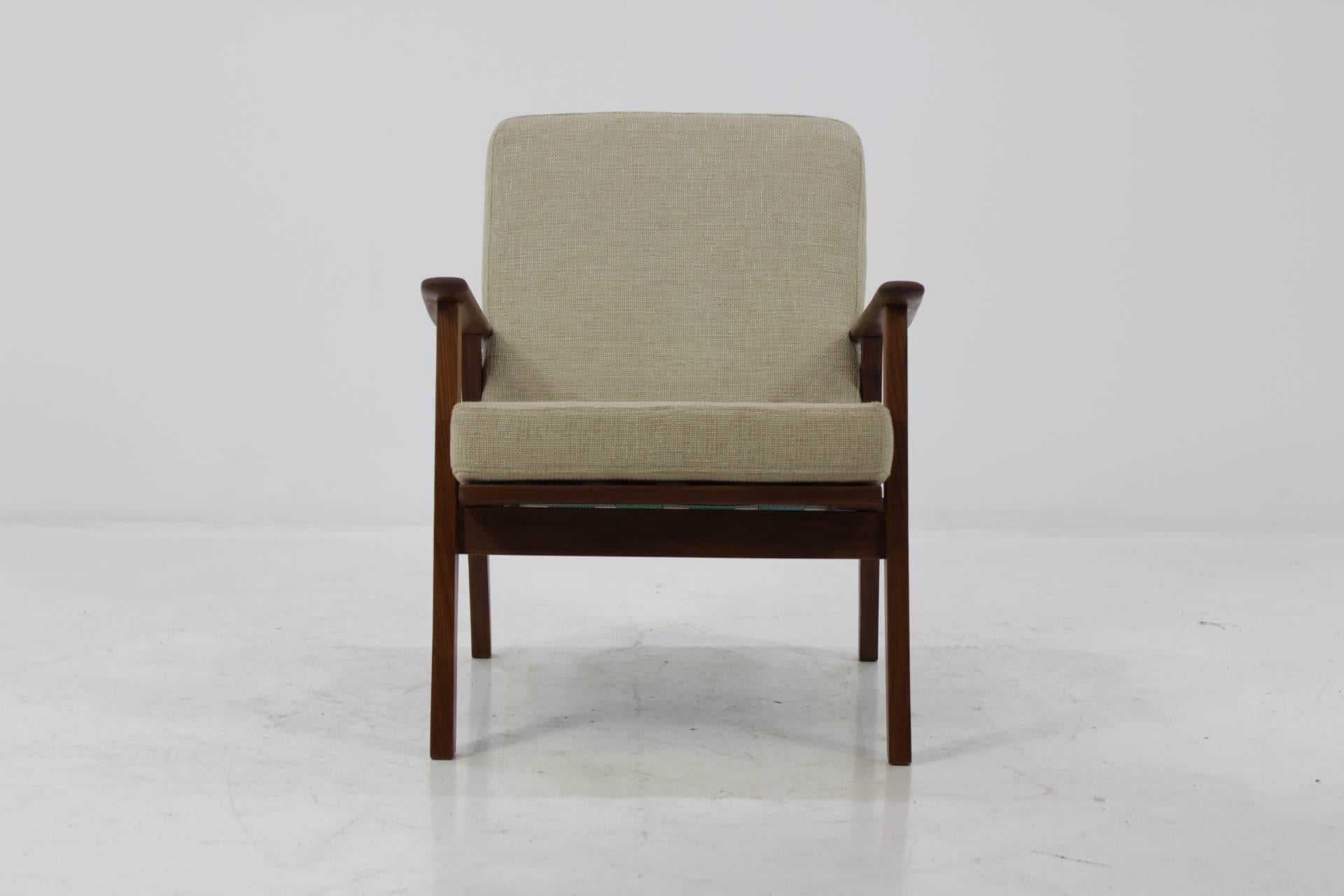 The chair features wooden teak frame and new fabric upholstery. Very good condition.