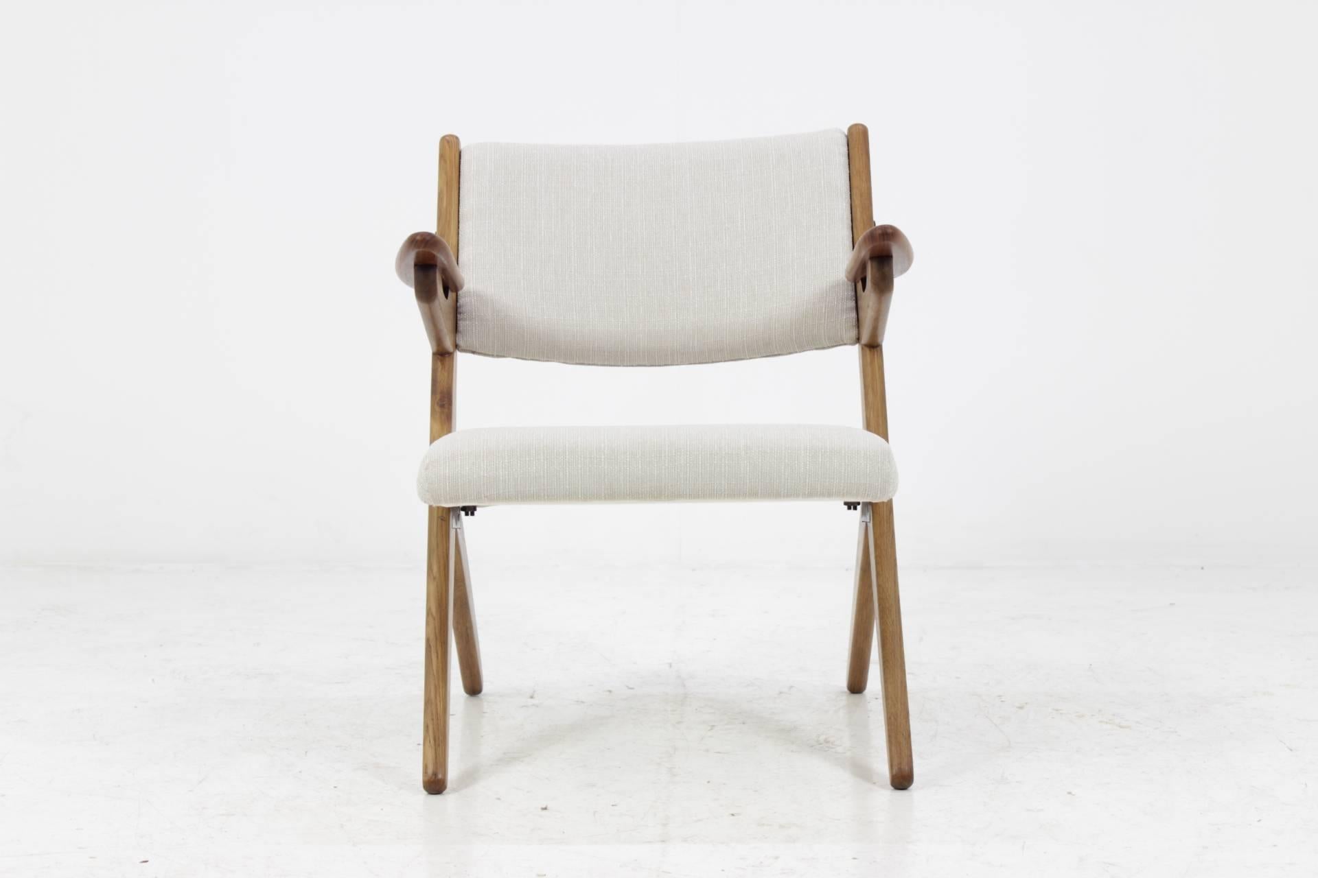 The chair features wooden oak frame and new fabric upholstery. Very good condition.