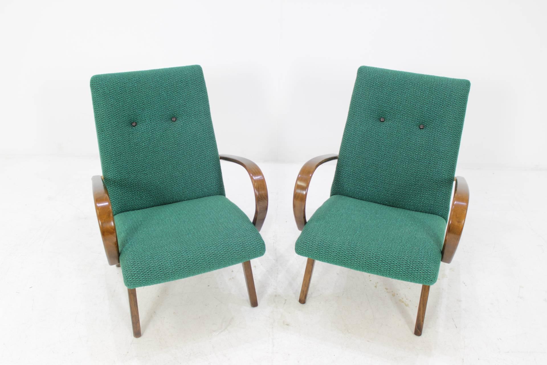 This chair was made in Czech Republic during 1960s by Thon Company (before Thonet). Legs and bentwood armrests are made from beech wood. The original fabric upholstery of both chairs is in excellent condition.