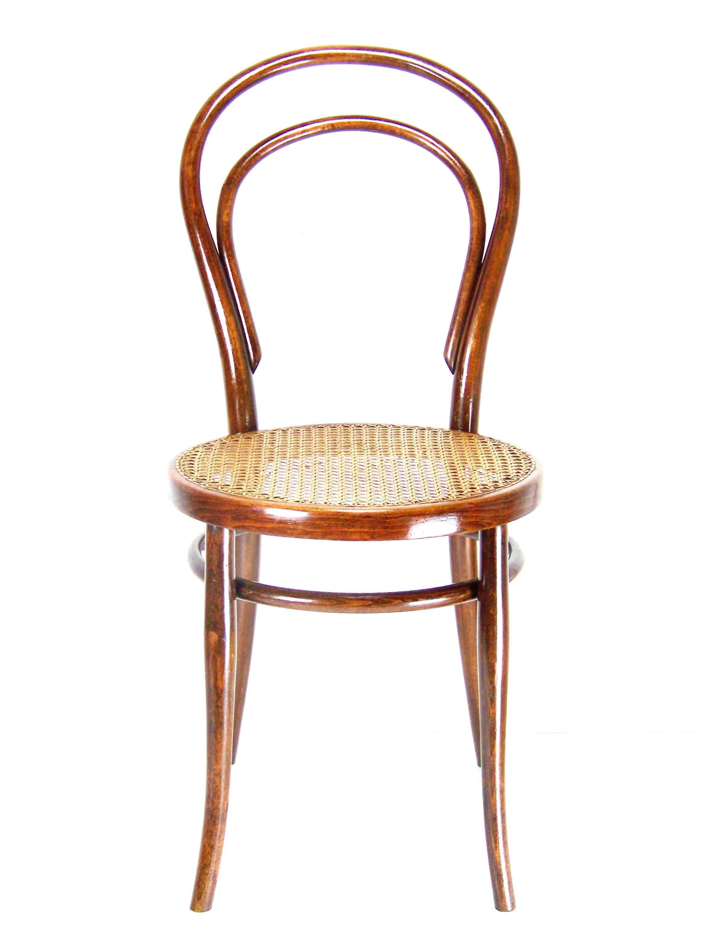 Manufactured in Austria by the Gebrüder Thonet Company. Marked with stamp and paper label under the seat. Chair was cleaned and gentle re-polished with shellack finish.