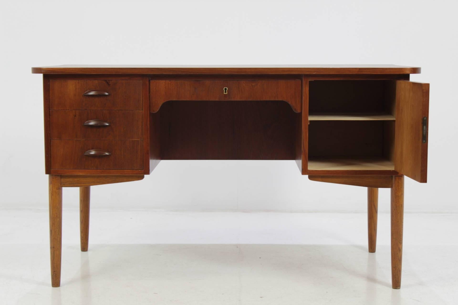 The desk features three drawers and one lockable compartment with door has open storage space on the back side . This item was carefully restored.