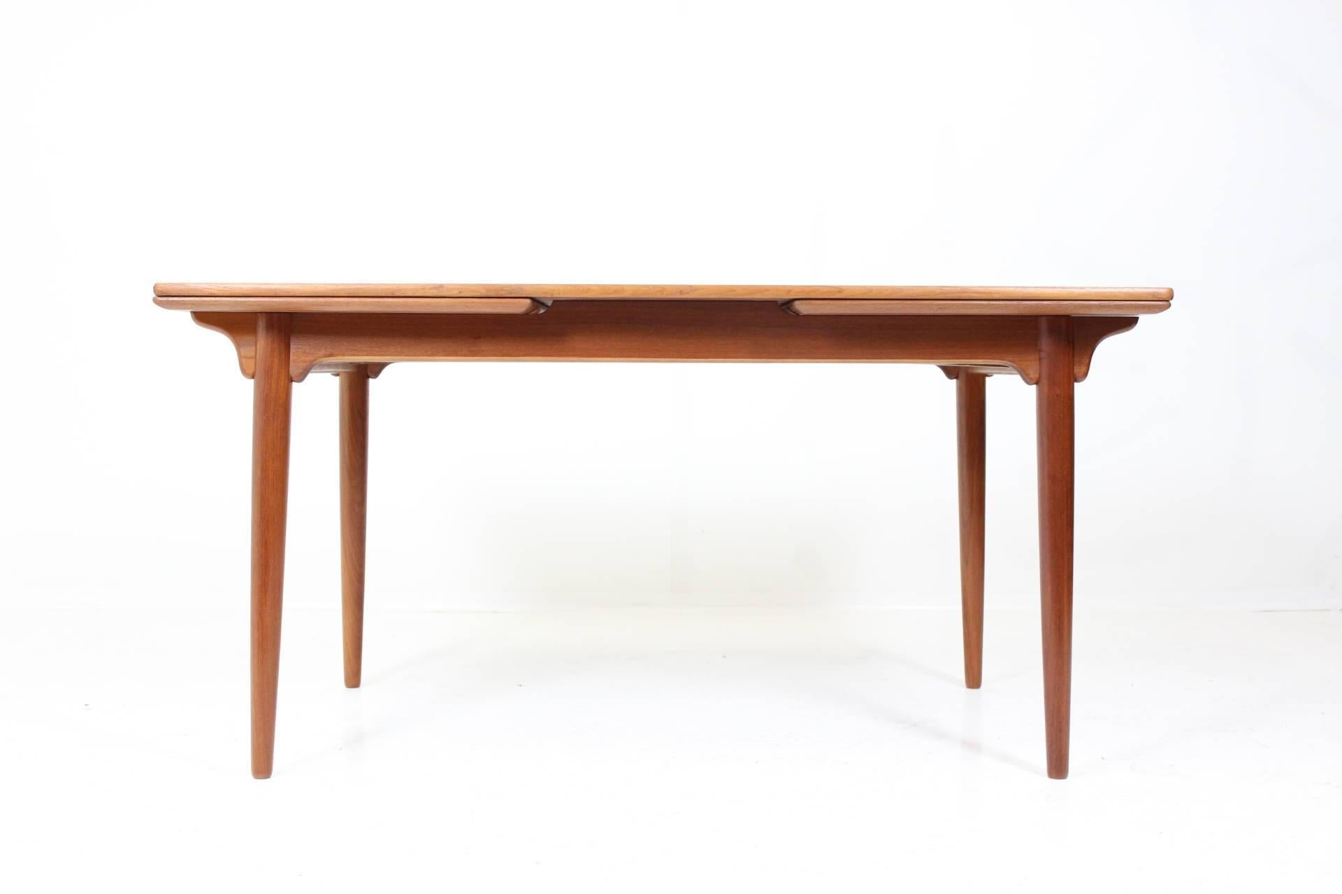 Dining table in teak by Gunni Omann with two extendable leaves (up to 253cm width). Model 54. Manufactured by Omann Jun. The item was carefully restored and it's in perfect condition.