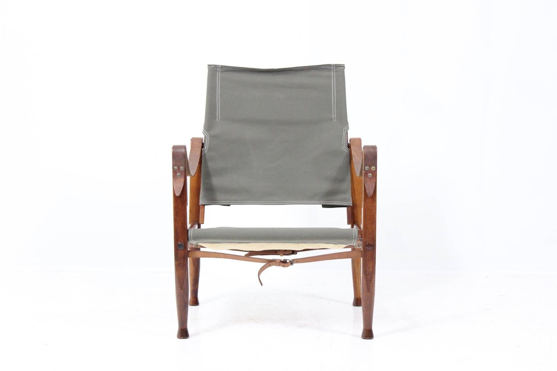 Armchair by Kaare Klint for Rud Rasmussen. A descendent of the English chair that generations of Englishmen took along on hunts in Africa and Asia. A famous design unchanged from the original almost 75 years ago. Carefully re-polished wood frame,