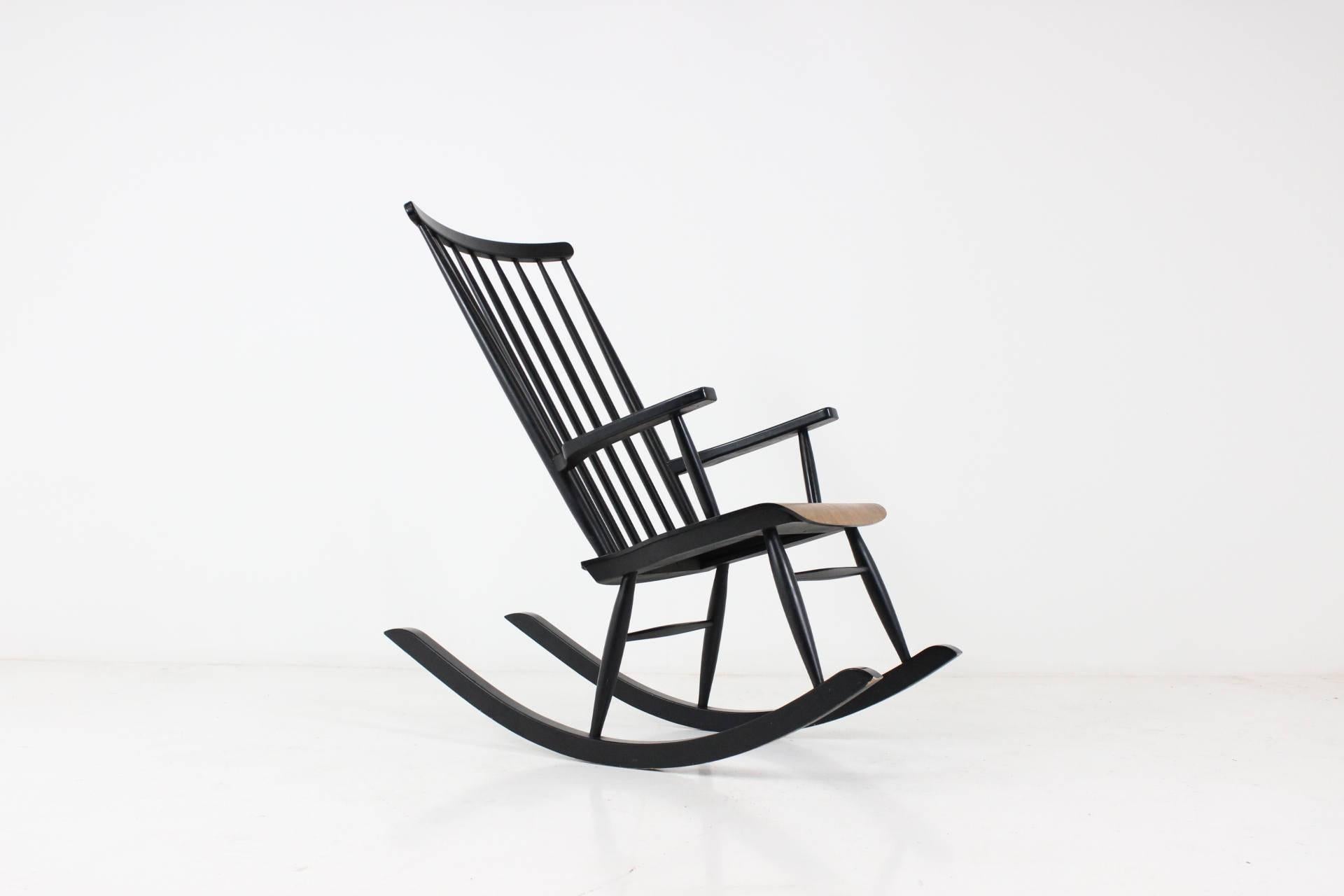 This rocking chair by Varjosen Puunjalostus for Uusikylä was made in Finland between the 1960s-1970s. Made from varnished wood, the piece displays some defects corresponding with use and age.