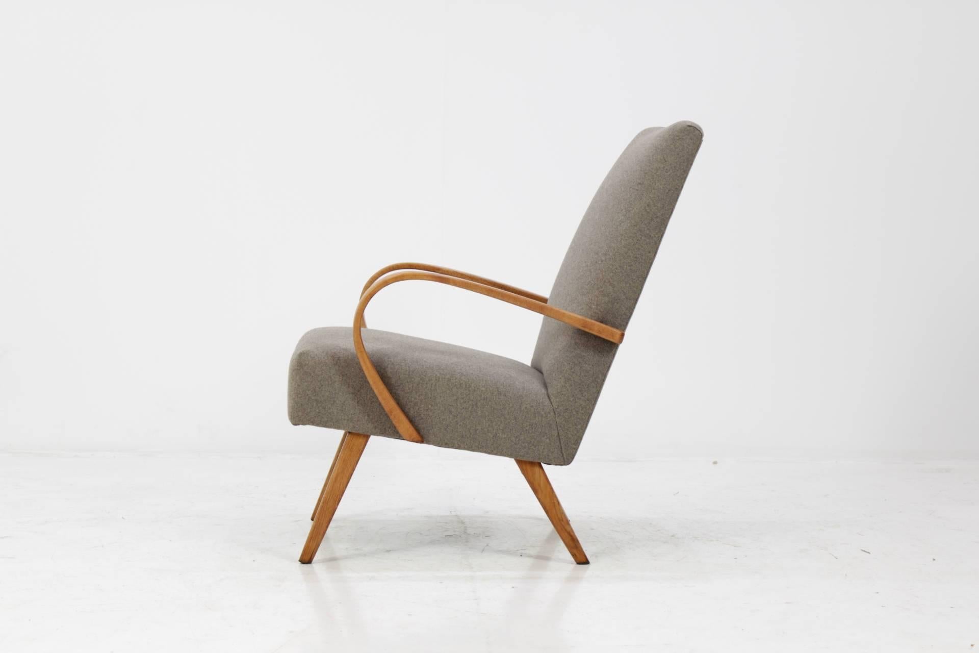 This chair was made in Czech Republic during 1960s by Thon company (before Thonet). Legs and bentwood armrests are made from beechwood and features new fabric upholstery. Very good condition.