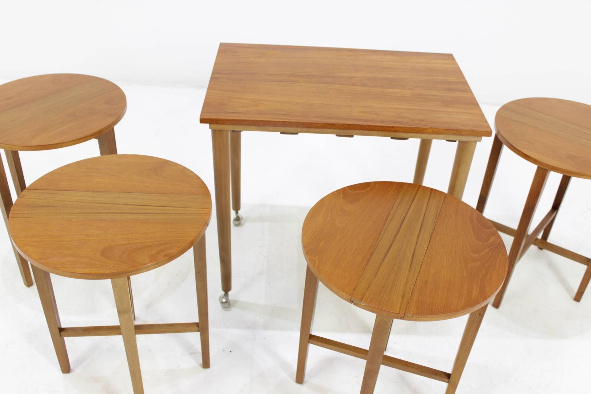 - Set of five nesting tables or one table and four stools
- Wood professionally rewired
- Material: teak.