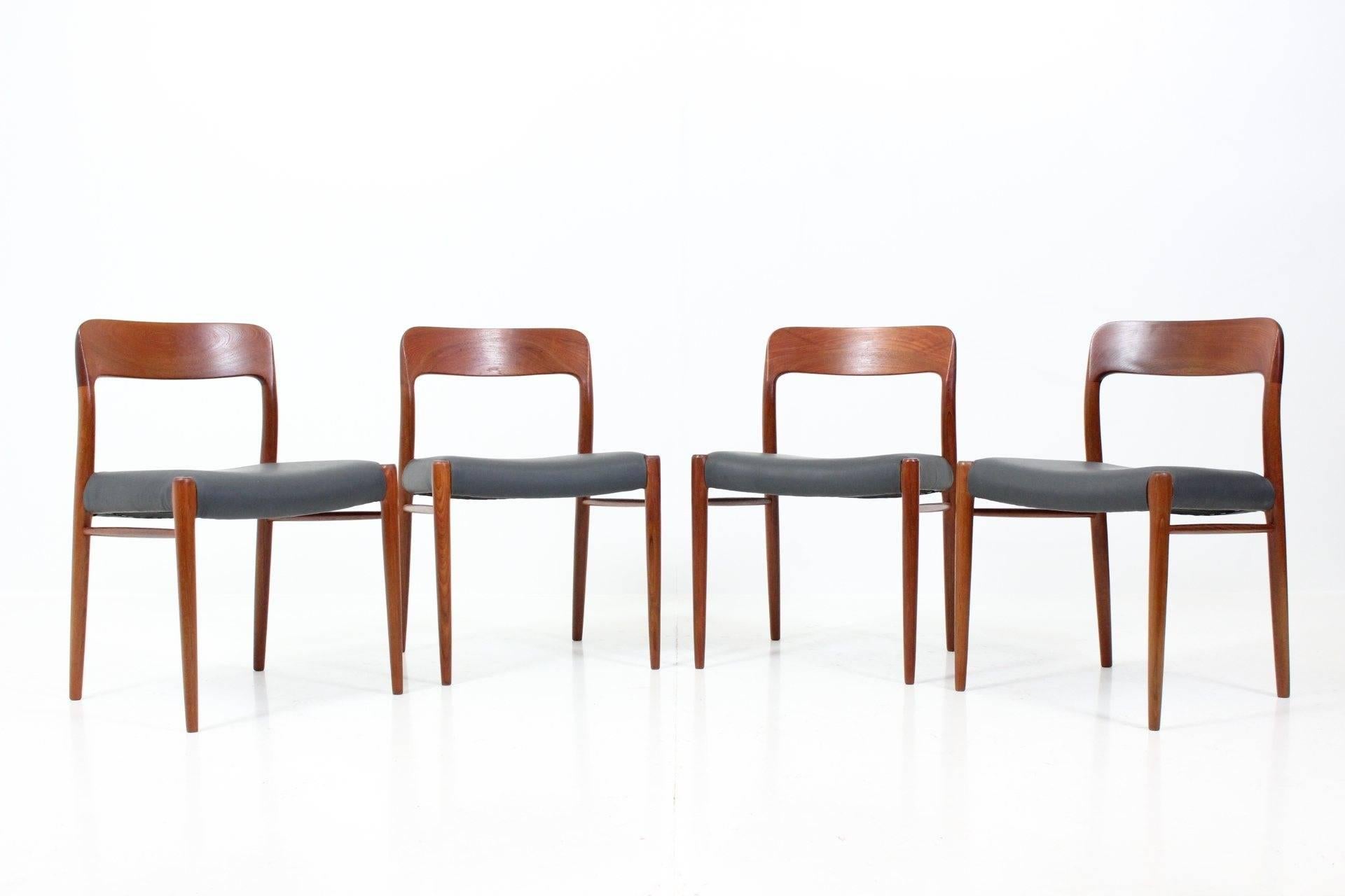 Set of four dining chairs in solid teak by Niels Otto Møller for J.L. Møllers Møbelfabrik featuring organic shaped back. The chairs have been carefully restored and have updated anthracite grey leather upholstery.