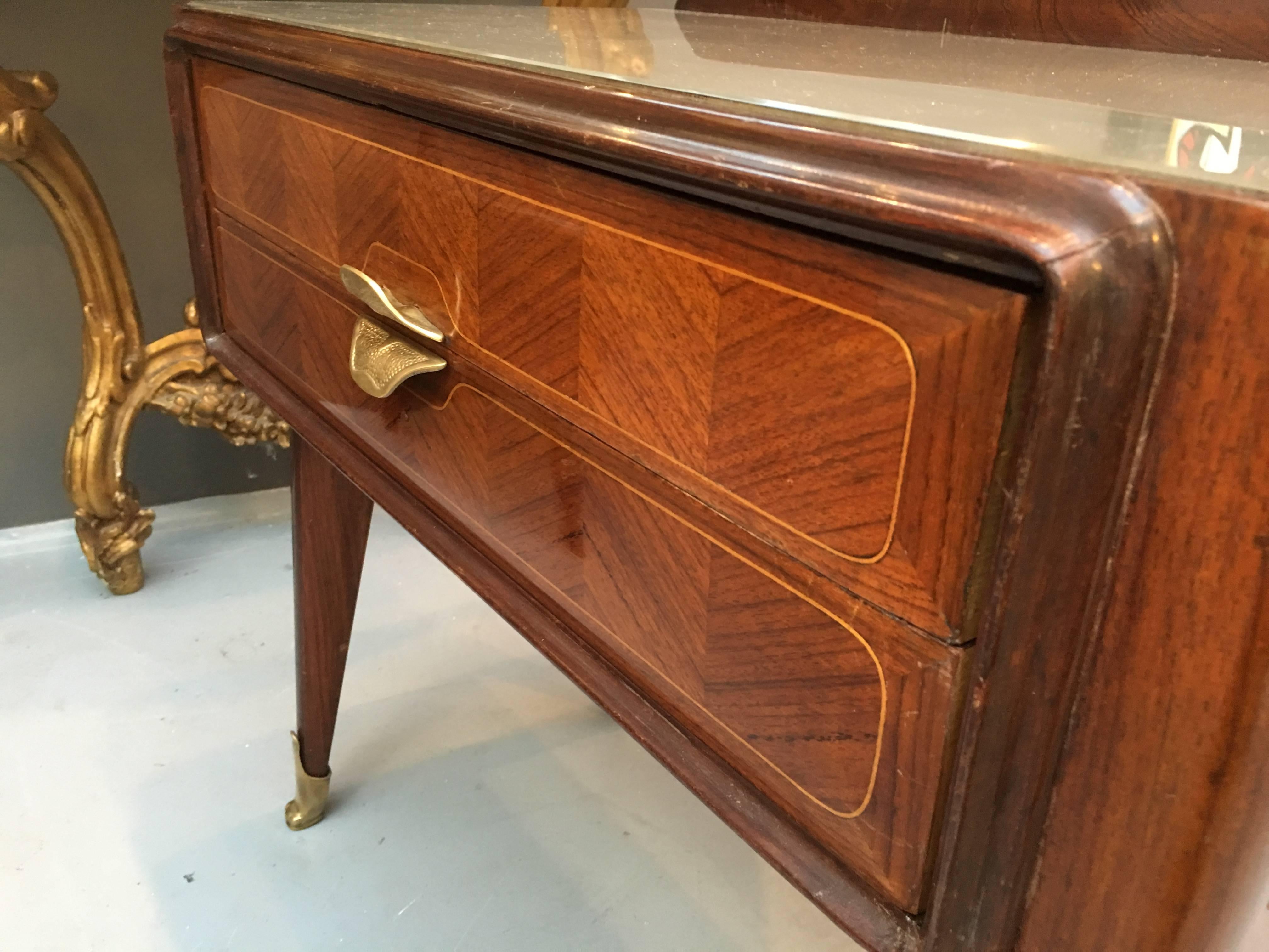 A really lovely pair of 1950s Italian 'Dassi' rosewood and satinwood parquetry decorated side tables with two drawers each.

Original gilt metal handles and feet as well as original glass tops.

Some usual signs of wear in places, but all part