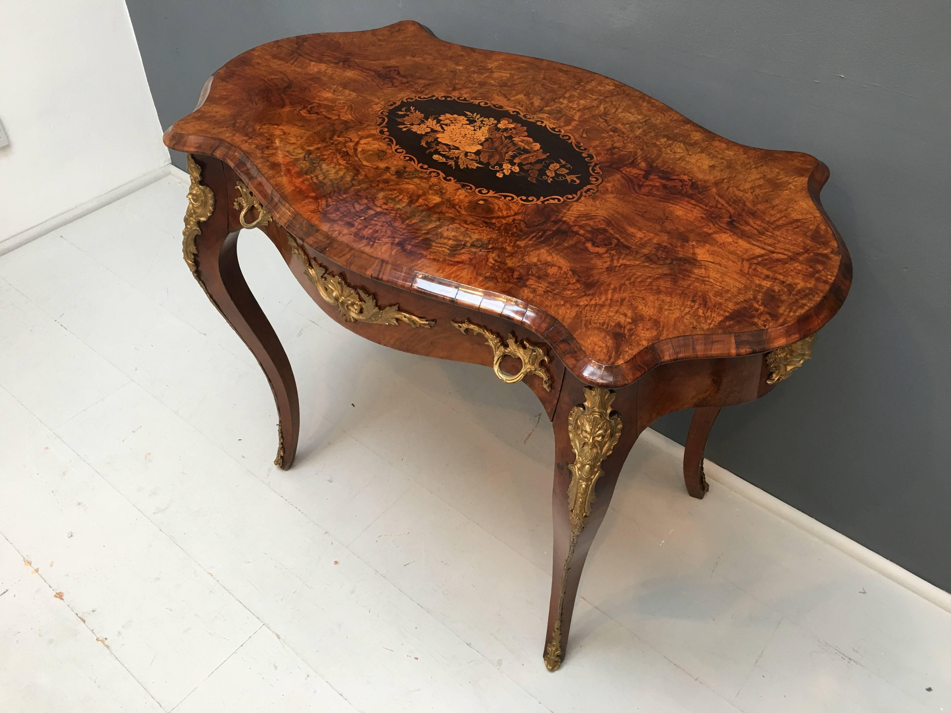 A superb 19th century serpentine shaped Napoleon III, circa 1870 burr walnut with ebony and satinwood marquetry inlaid writing or centre table

Cabriole legs and gilt mounted and in beautiful condition.
 