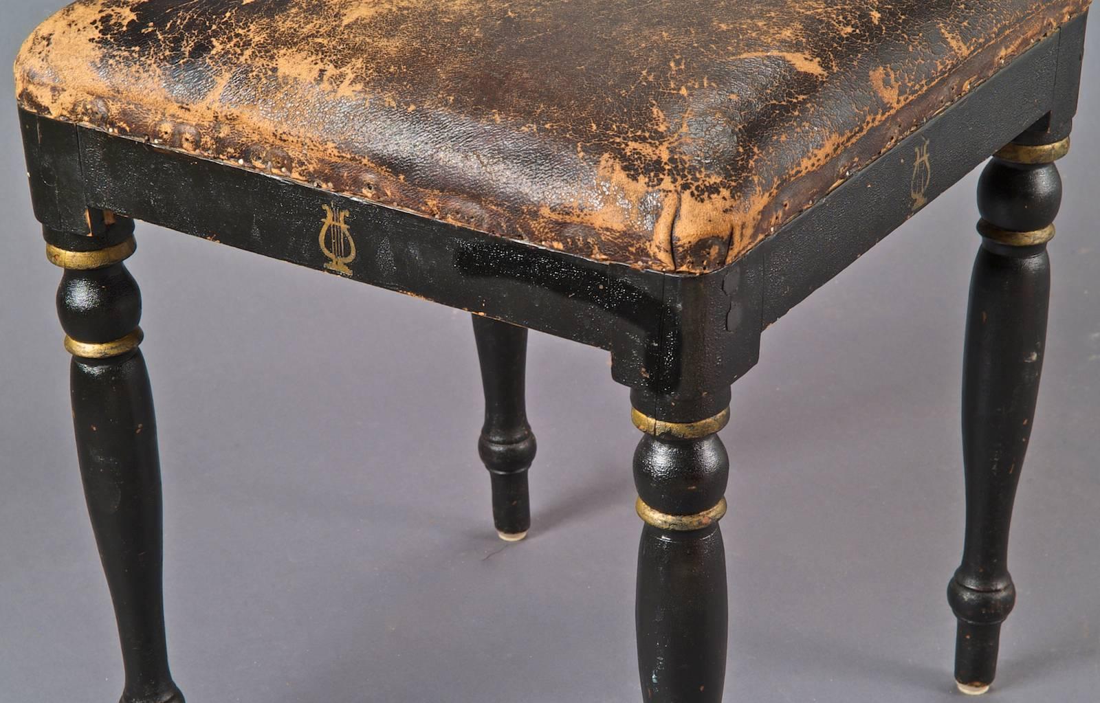 Square seating stool, covered with his original brown leather, on four plump legs in blackened wood with golden painted lyres.
Sweden, 18th century. Dimensions: 15.35 X h 17.72 in.