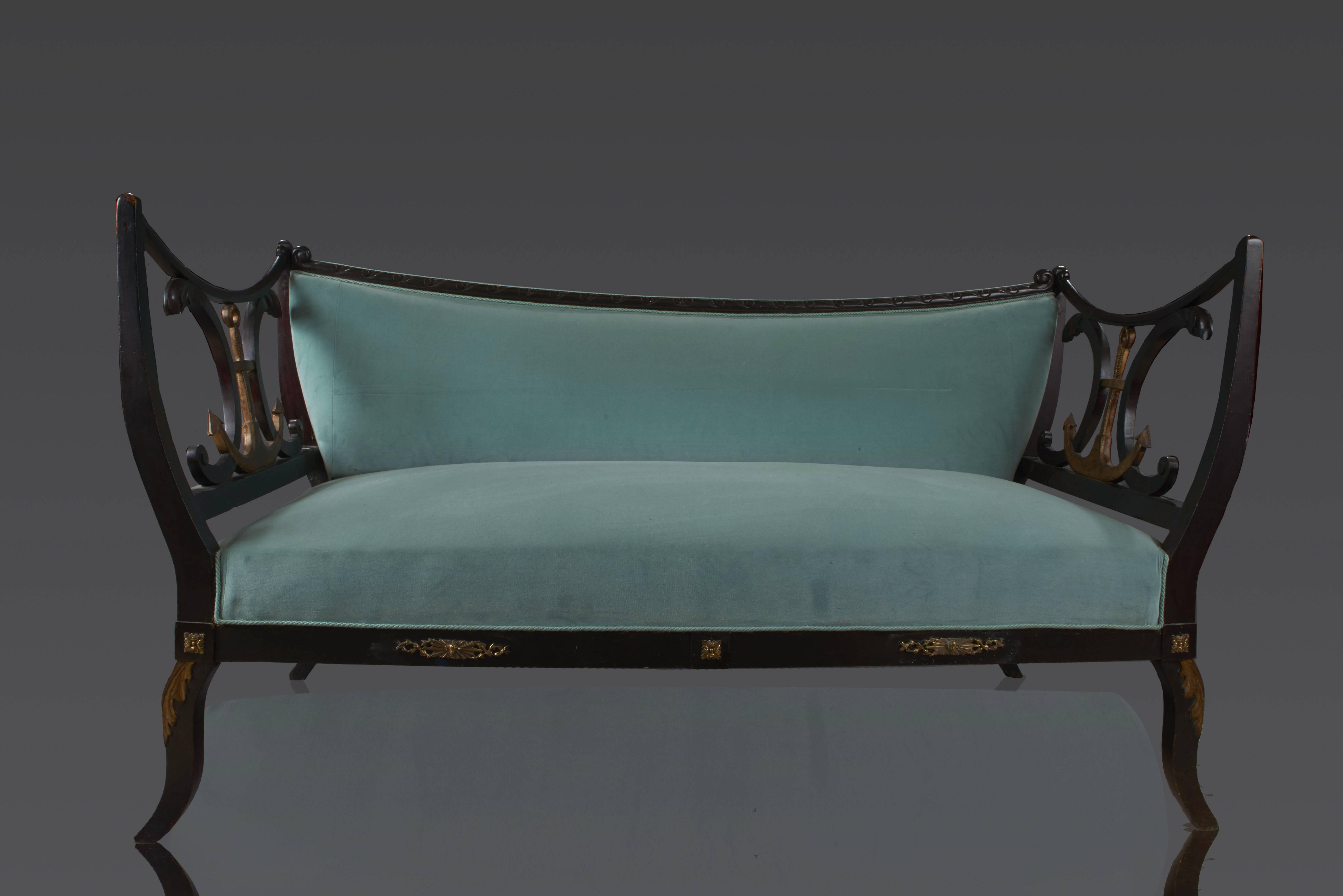 Sofa made of mahogany - carved with waves and leaves - covered with turquoise silk velvet - back lightly incurvated - armrests with golden marine anchors and interlacings - the anchor is the emblem of Hamburg and the sofa was probably made for this