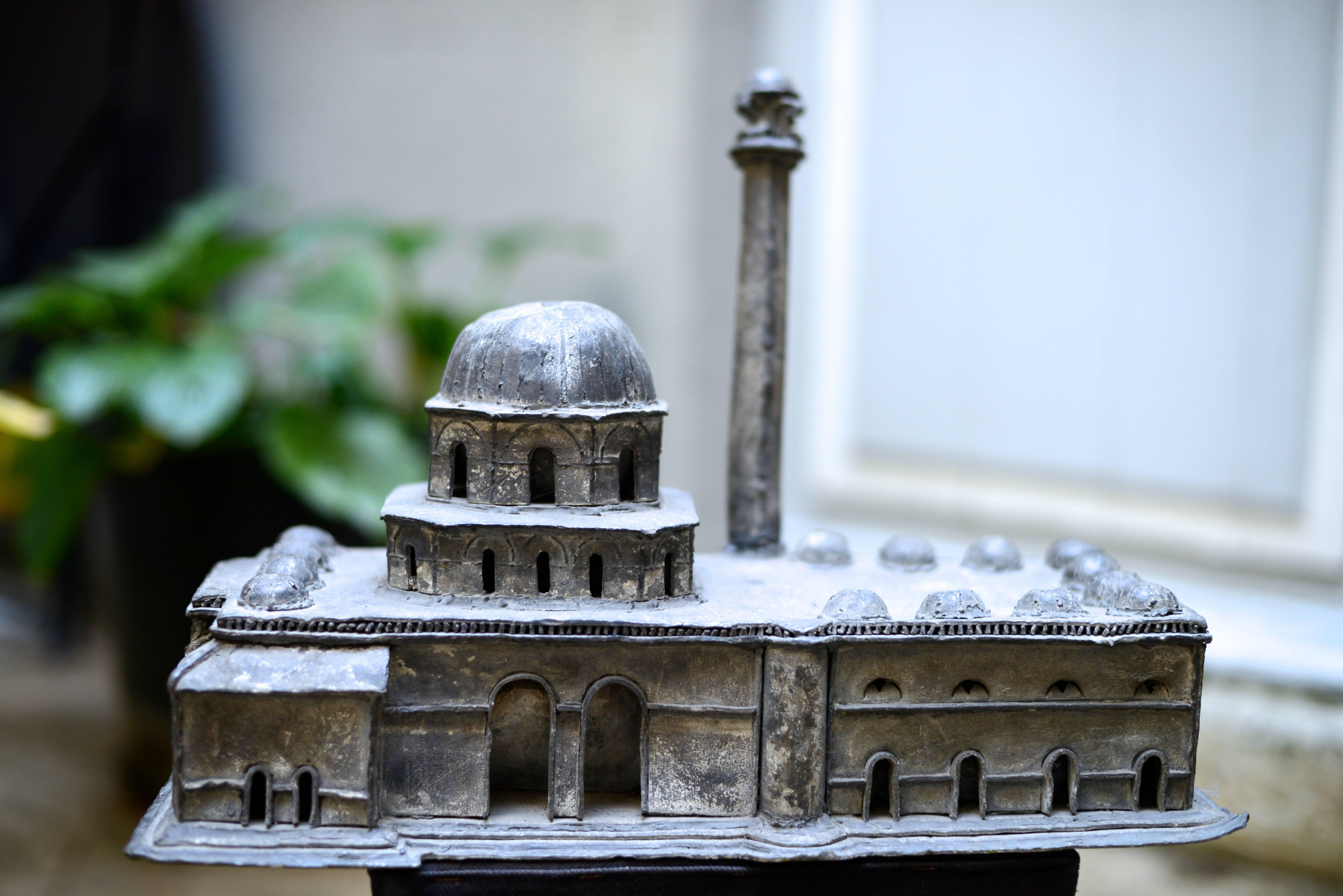Amazing model made in lead - evoking a Middle East mosque - the building opening with several arched doors - on top, step dome and minaret. 
Tunisia, 19th century 
Dimensions: L 42.5 X W 20.5 X H 32 cm.