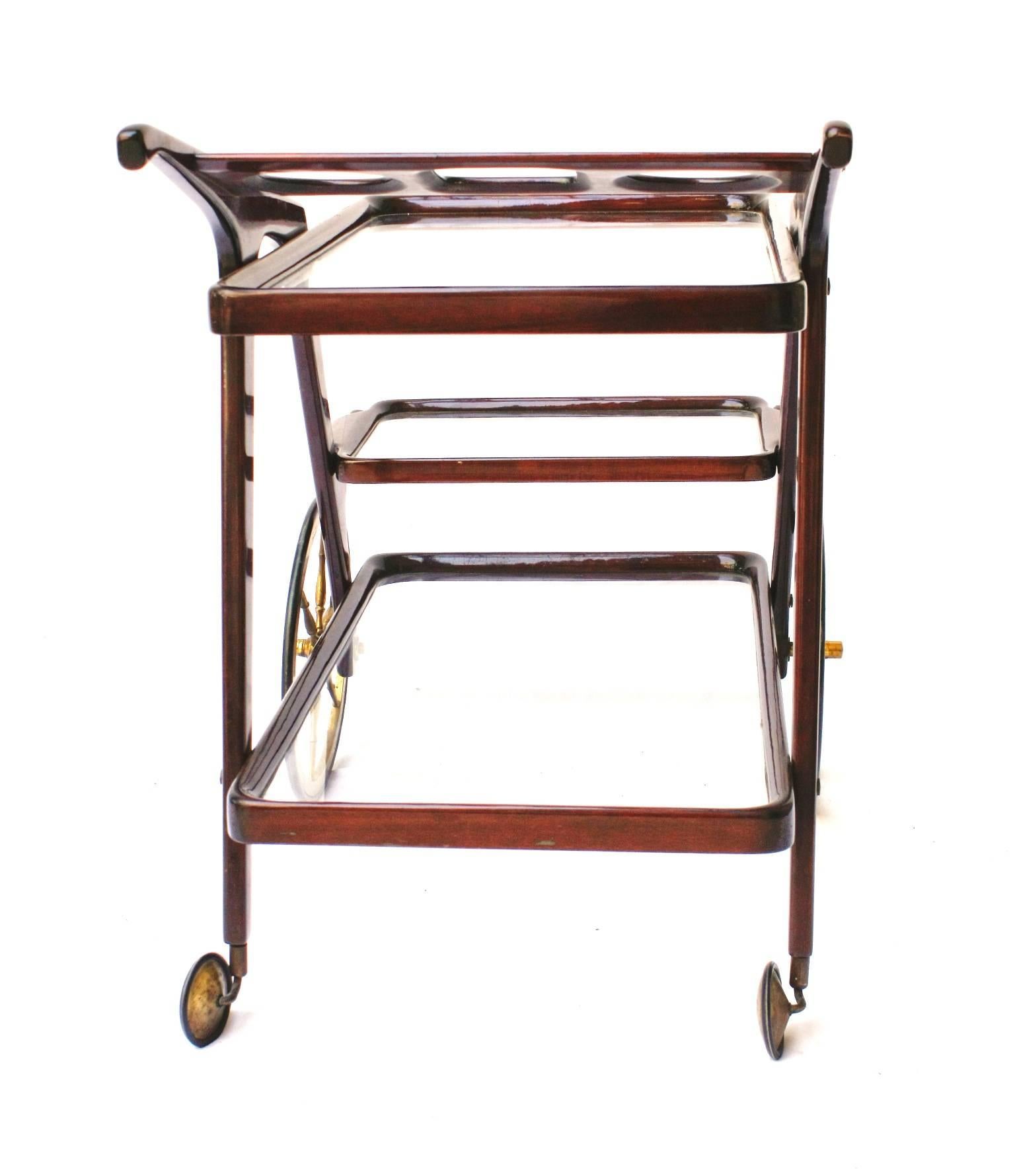 Cesare Lacca, wood, brass and glass serving cart. Extractable tray and bottle rack, circa 1950.