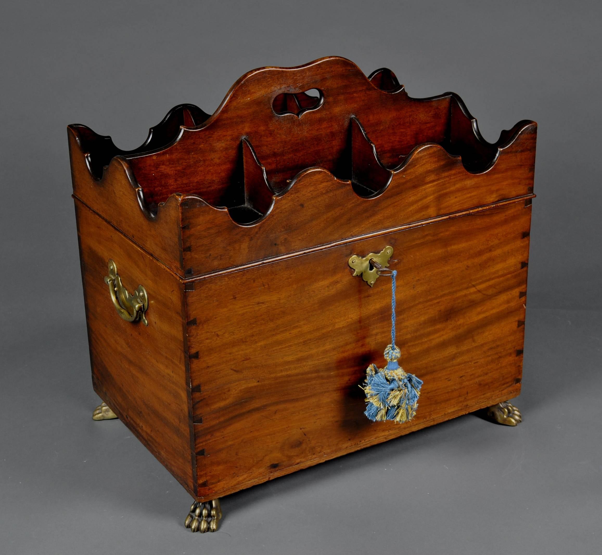 A rare and unusual 18th century mahogany box cellarette, the hinged lid with shaped partitions for six bottles, opening to reveal a similarly partitioned interior. Standing on brass paw feet with castors.