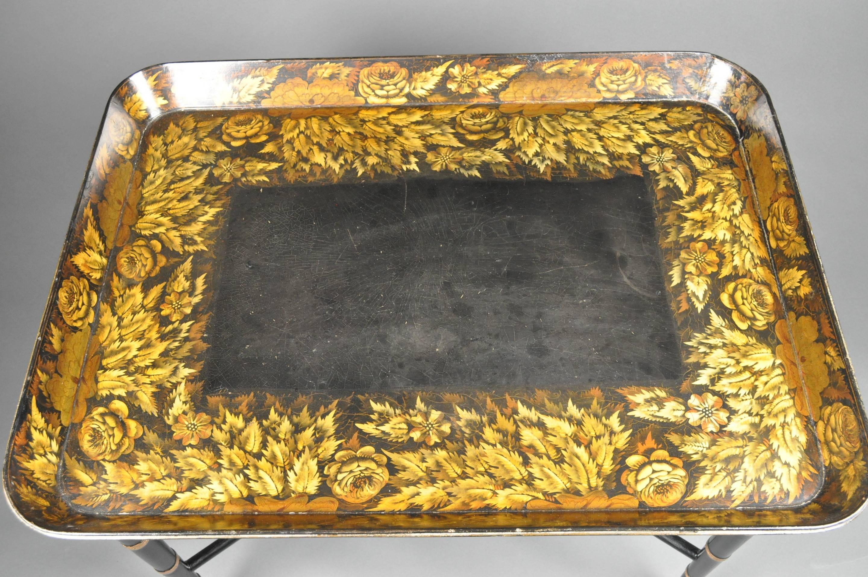 A fine quality early 19th century large black Papier Mâché tray, the wide borders and gallery decorated with hand-painted fern leaves and flower-heads. Signed underneath ‘CLAY, KING ST, COVT GARDEN’. Mounted on a modern stand.