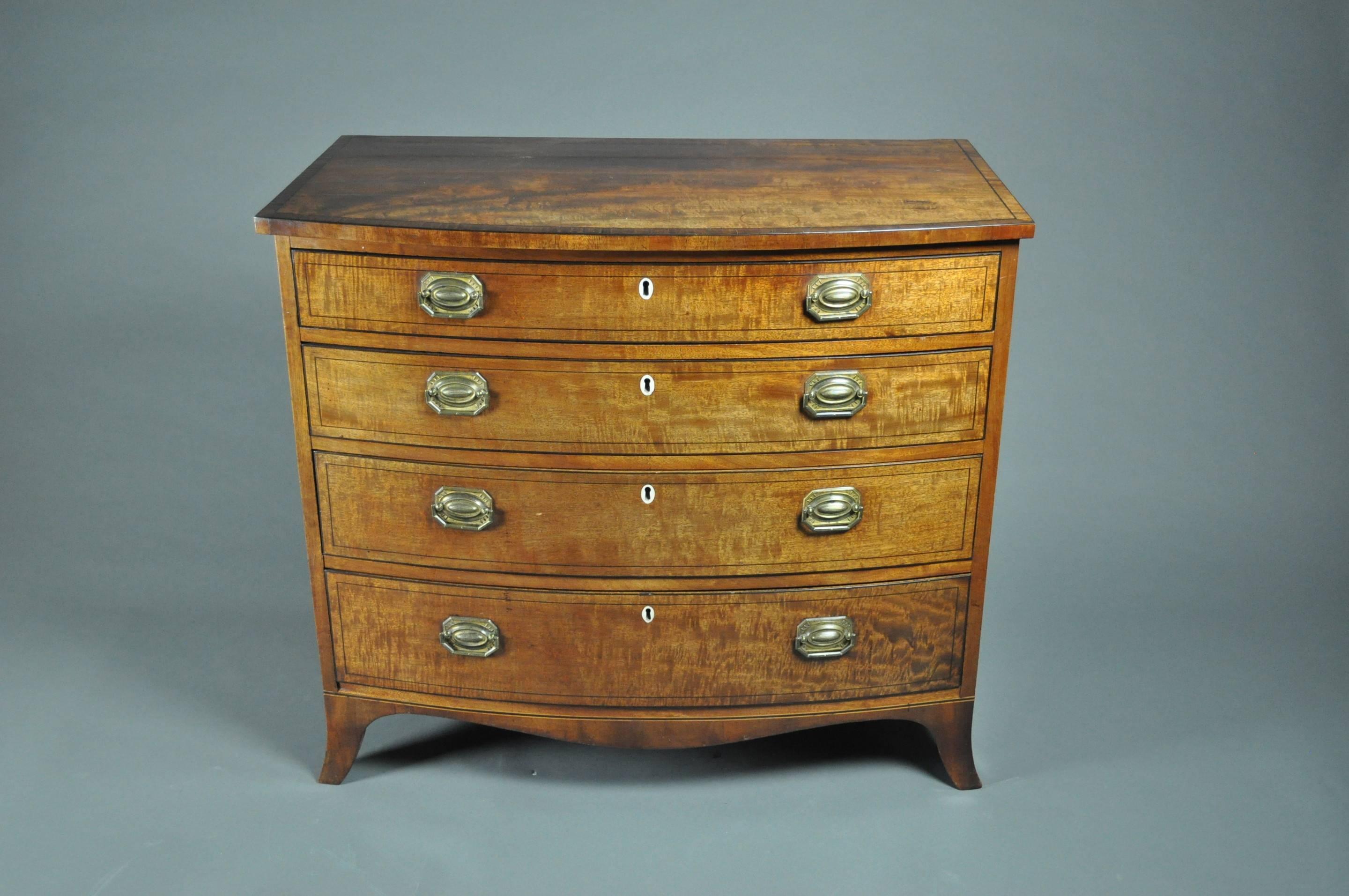 A good early 19th century mahogany bow-fronted chest of four graduated drawers, inlaid with boxwood and ebonized stringing and standing on splayed bracket feet with shaped apron. 
Original handles and excellent color.