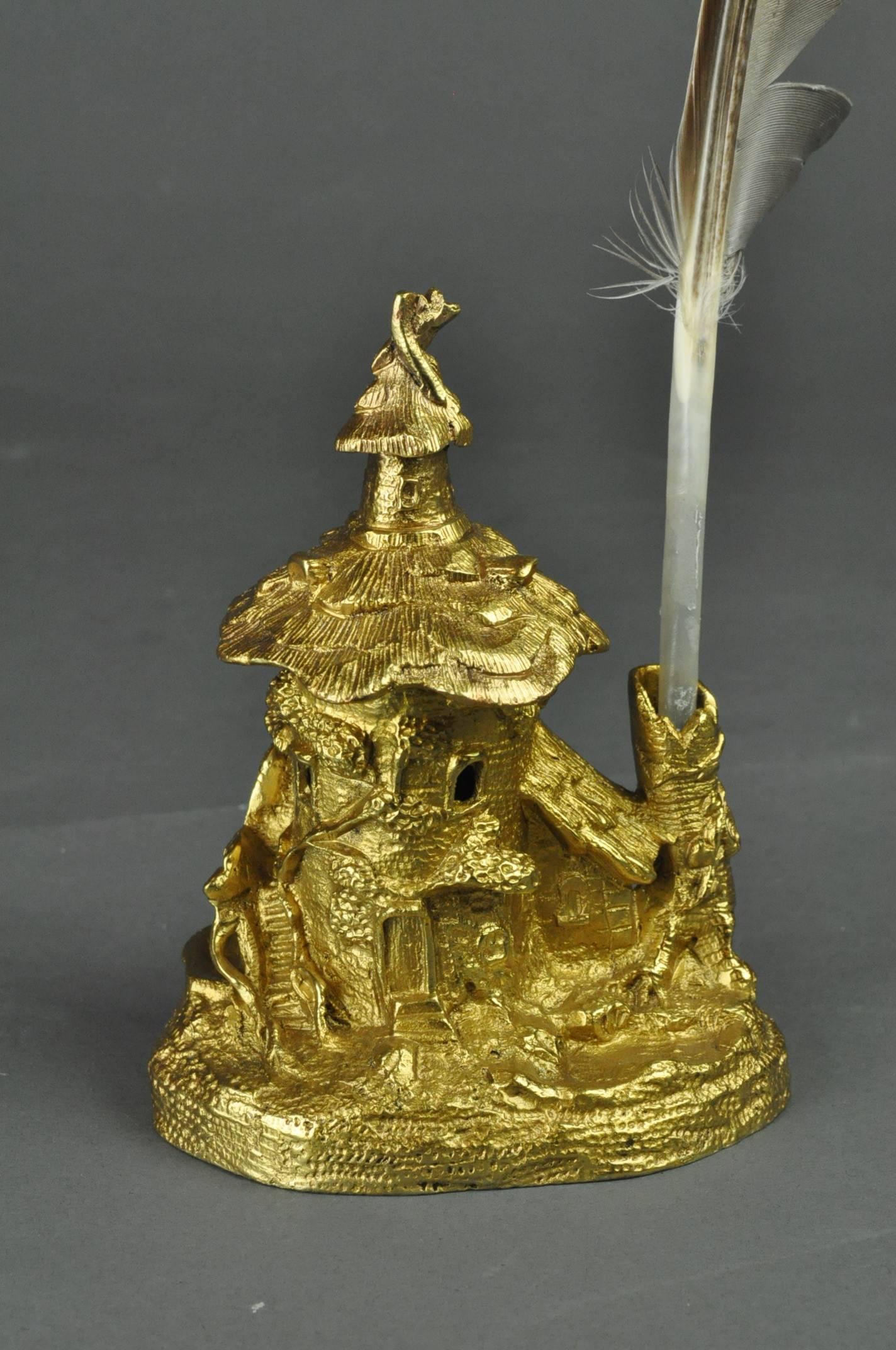 An attractive late 19th century ormolu inkwell in the form of a mythical woodland house, approached by a rickety sweeping staircase. Probably French.
   