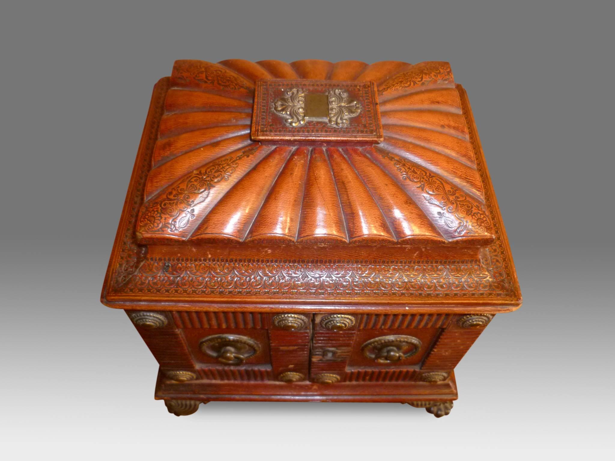 Very fine quality Regency period red leather covered sewing box, the gadrooned, cushion shaped top with tooled edge above a pair of gilt metal mounted panel doors surrounded by reeded egdes and opening to reveal three green fronted drawers lined in