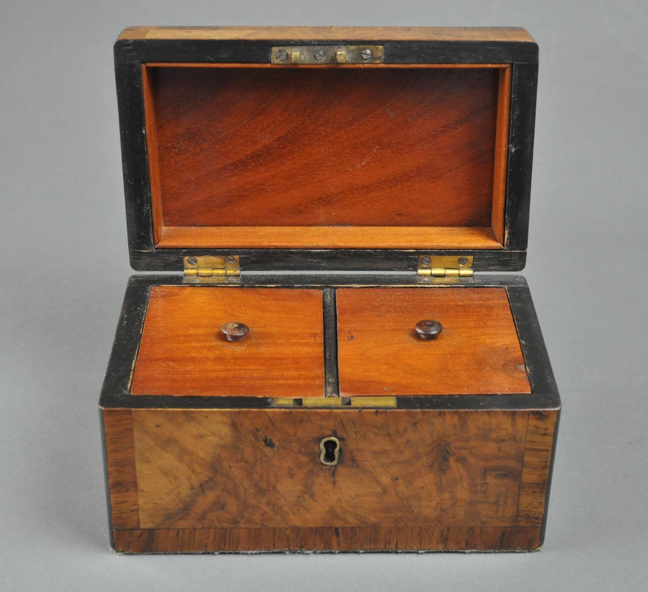 An early 19th century walnut two compartment tea caddy banded in rosewood.
         