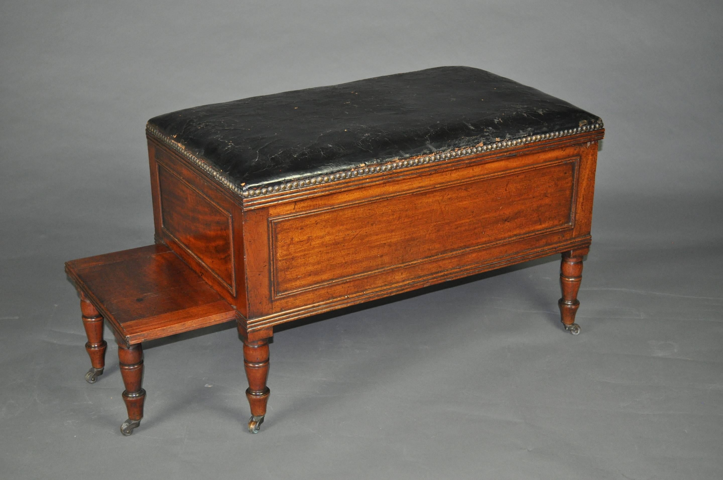 A rare and unusual metamorphic Regency stool which converts to a set of Library steps. The rectangular top covered in the original black leather above panelled sides and raised on ring-turned legs with brass cups and castors. The top opening to