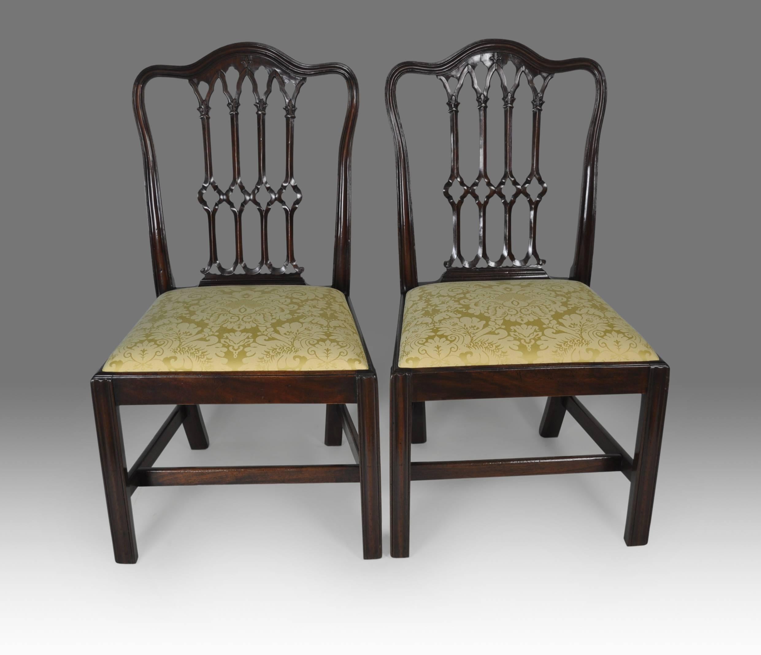 A good pair of Gothic Chippendale design mahogany side chairs, with carved interlaced lattice splats within shaped and moulded hoop backs above drop-in seats and standing on moulded and chamfered square legs with stretchers.