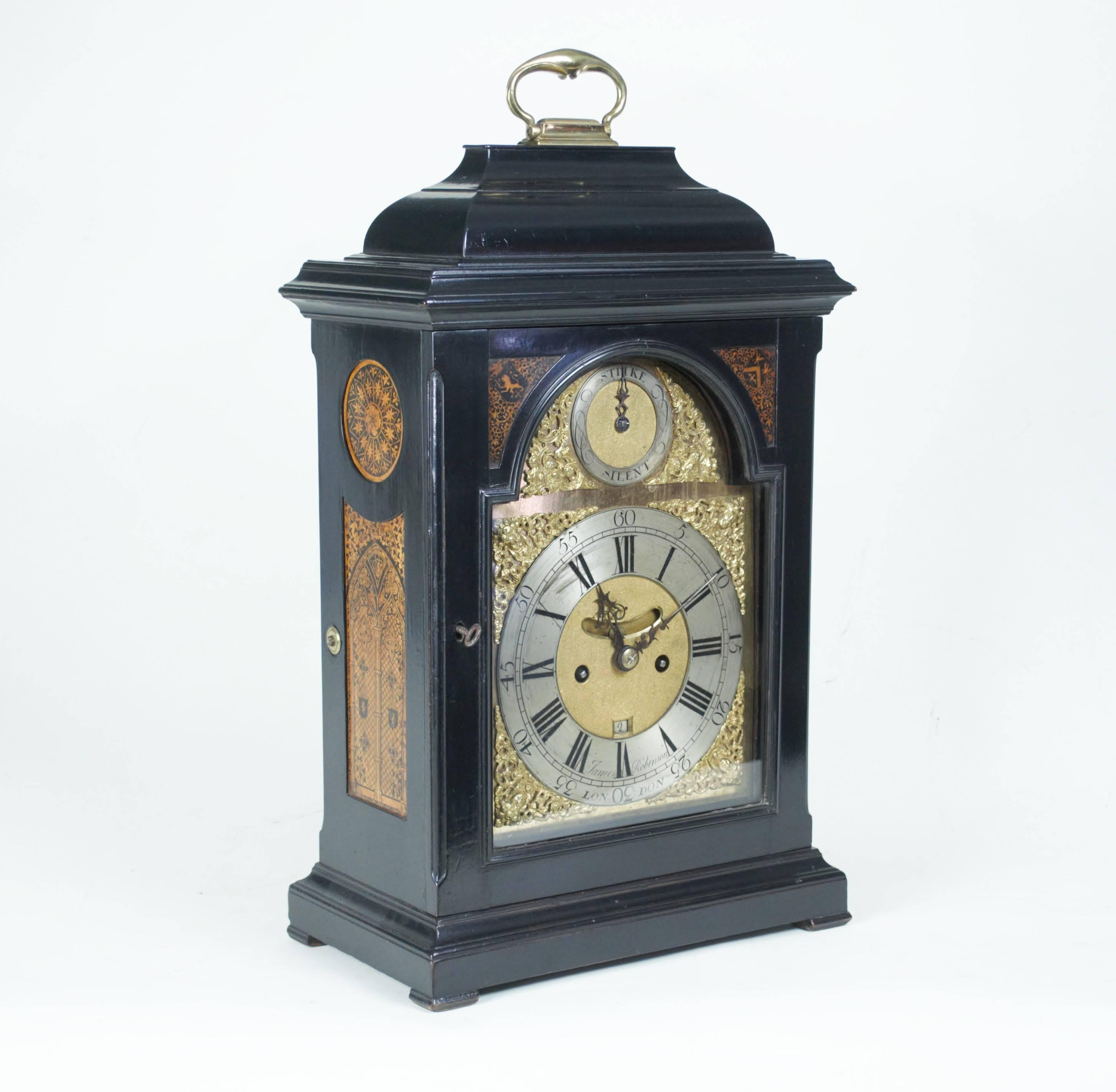 A mid-18th century cushion-top ebonized table clock, the case with pen-work panels enclosing an eight day chiming movement with finely engraved back-plate. Silvered dial with Roman numerals and gilt spandrels, stike/silent dial, pendulum and date