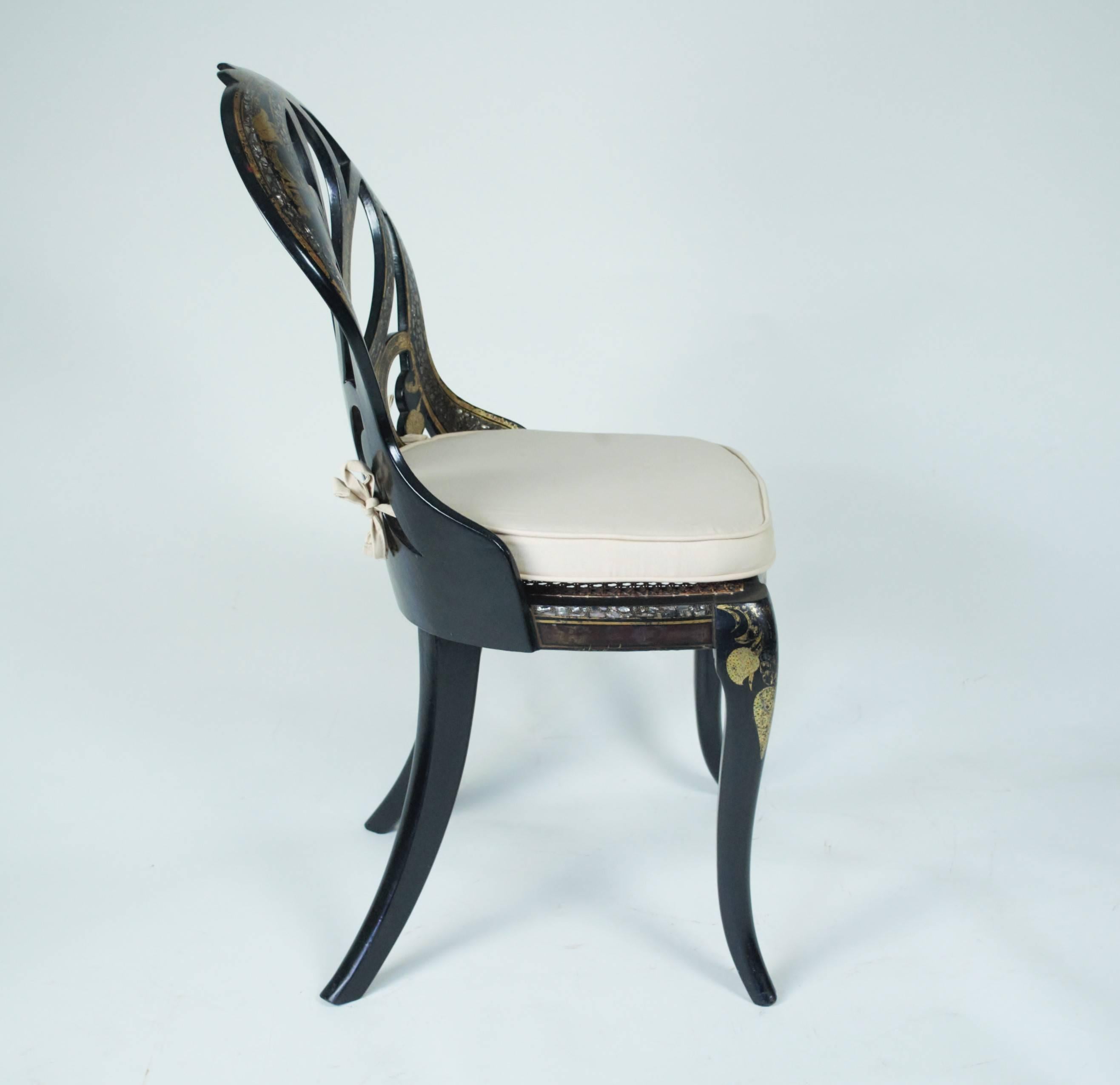 An outstanding pair of exhibition standard black Japanned side chairs by John Bettridge of Birmingham, each with metal makers labels under the seat rails. The backs, legs and seat rails profusely decorated with gold leaf, painted highlights and