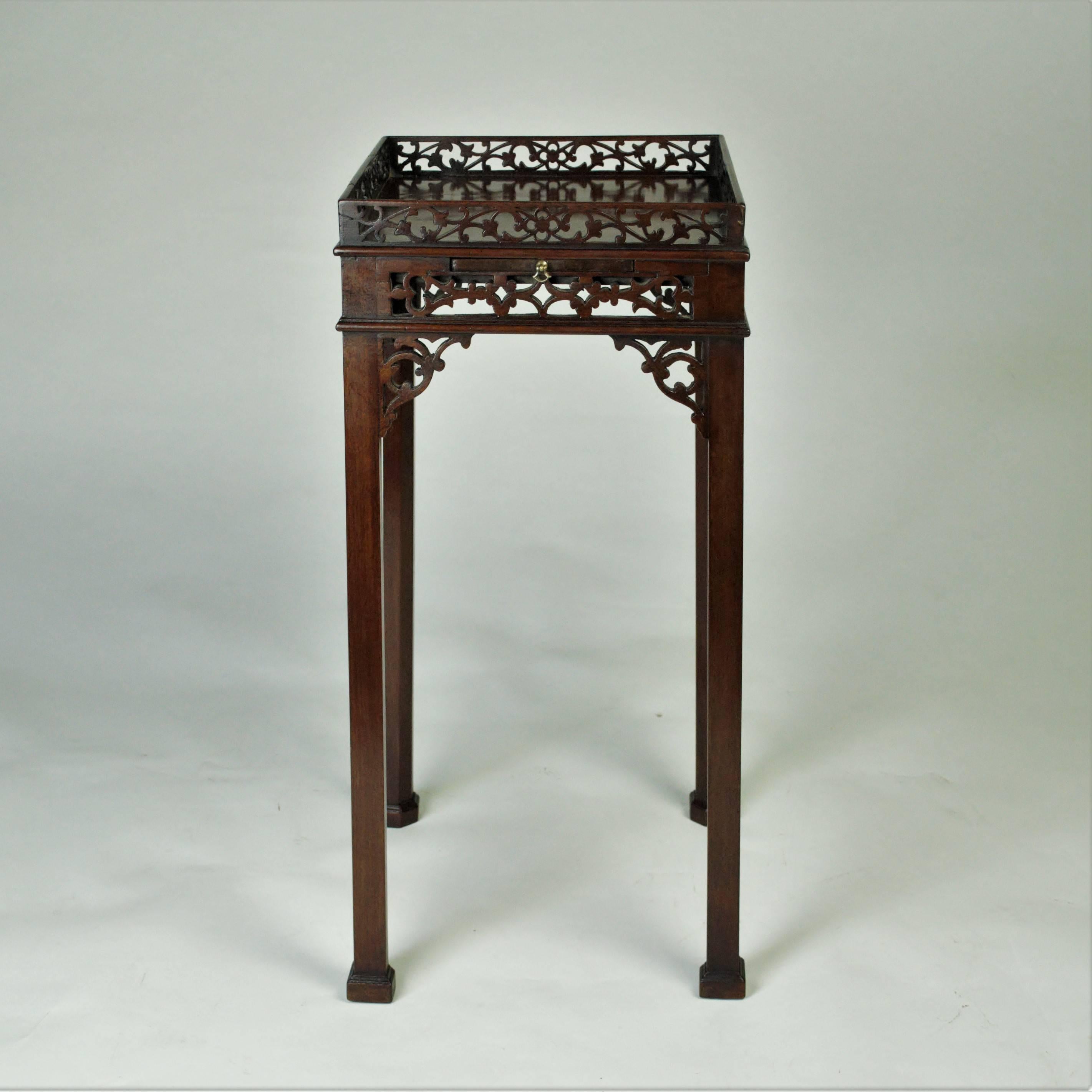 A fine quality Chippendale inspired and unusual mahogany Urn or Kettle Stand of square form with open-fret galleried top and apron set with a cup slide in the front, and standing on elegant chamfered legs with block toes and joined by a turned 'X'