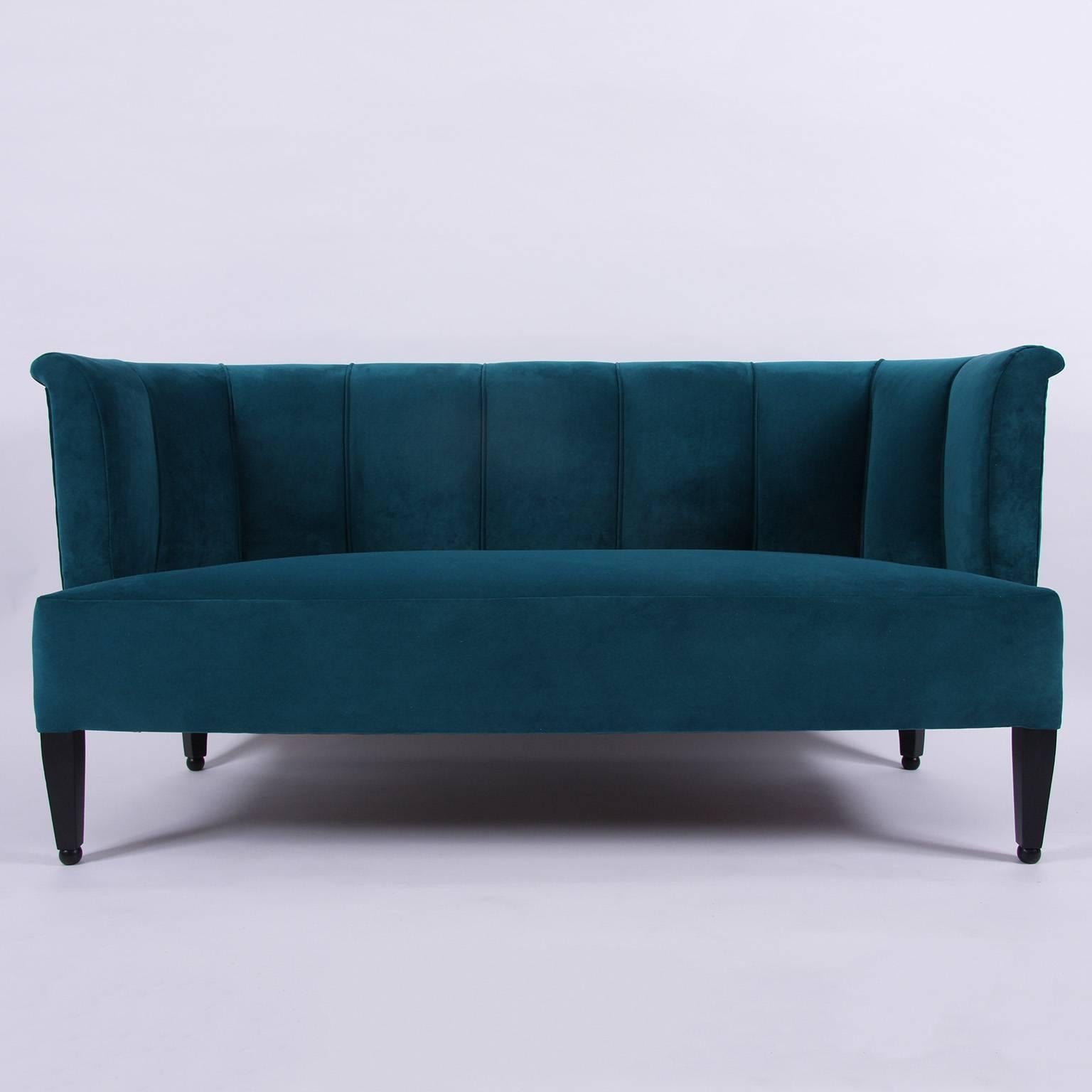 A sofa designed by Josef Hoffmann (1870-1956) by Whittman, newly re-upholstered in a teal velvet. On square tapering legs.

In 1912 Hoffman designed a suite of furniture for the music room of Dr. Hugo Koller in Vienna. This sofa was derived from