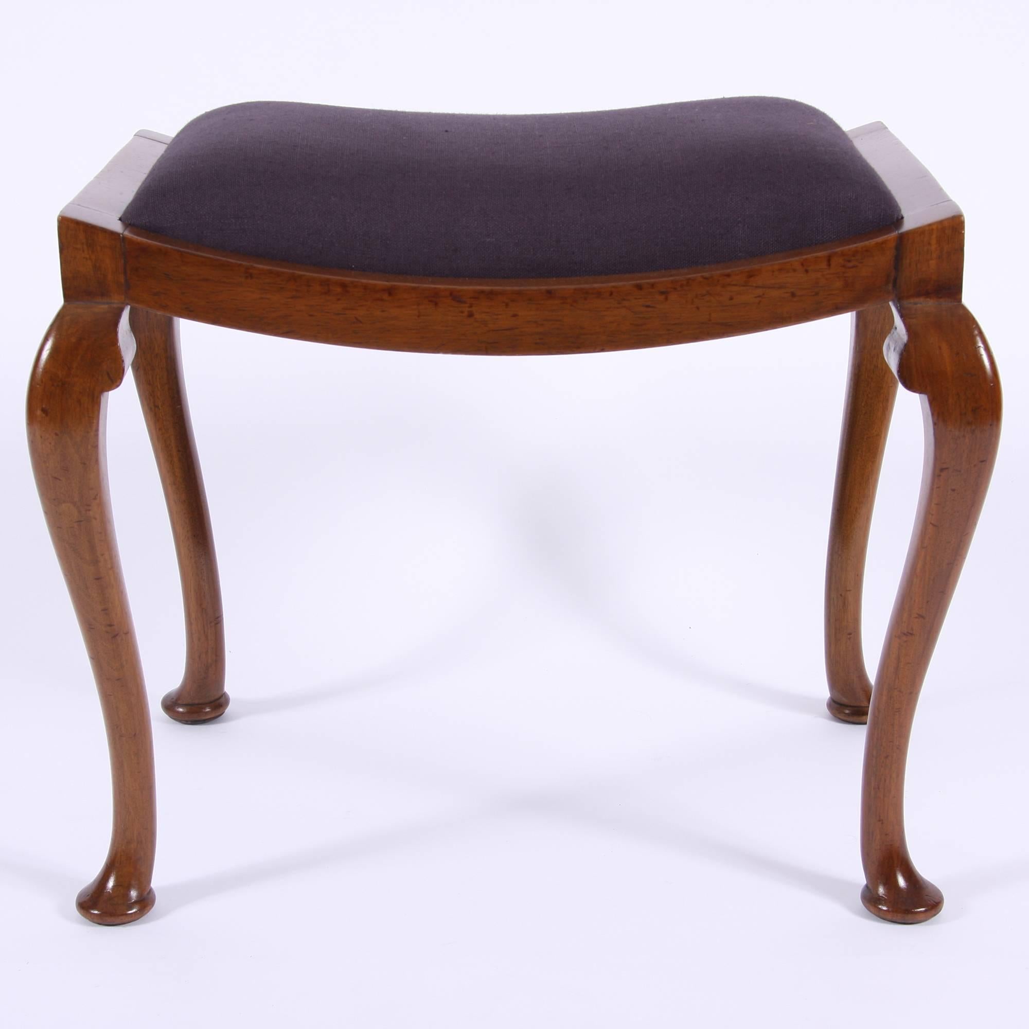 A very elegant early 20th century mahogany stool, perfect for use with a piano or dressing table. Newly upholstered seat pad.