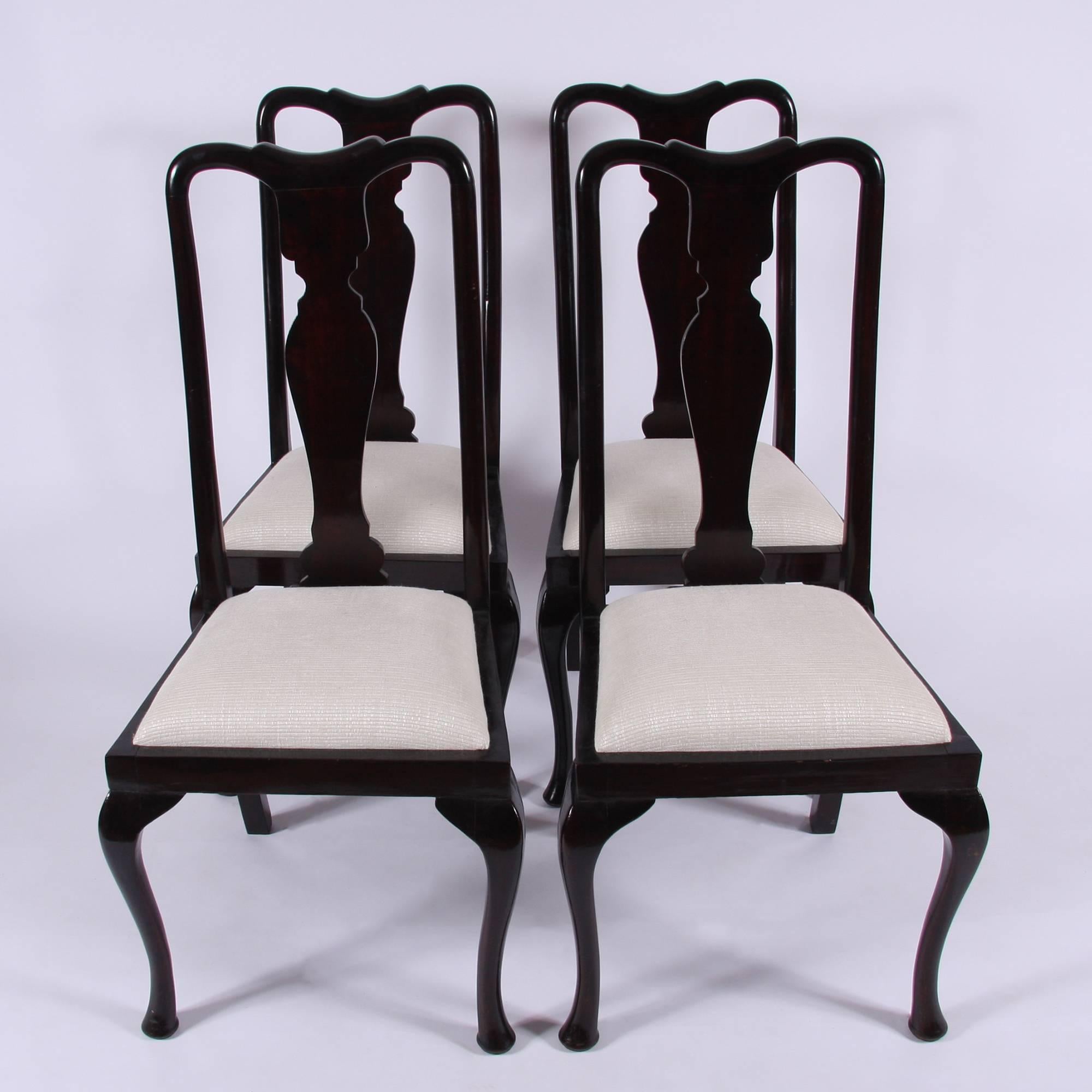 A stunning set of four early 20th century English Queen Anne style chairs in mahogany with newly upholstered seat pads.