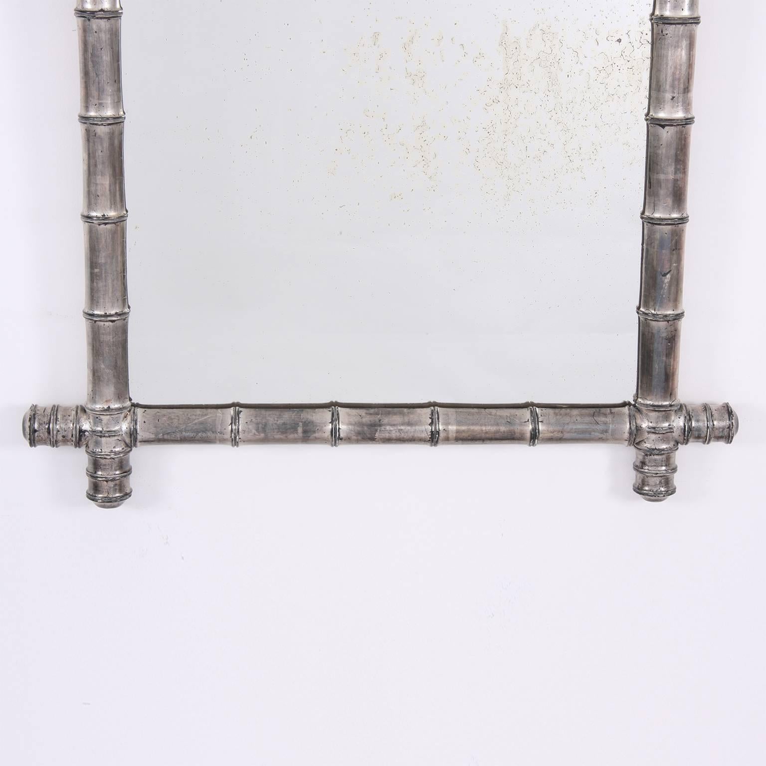 This is a gorgeous silver leaf, faux bamboo mirror with antiqued glass.