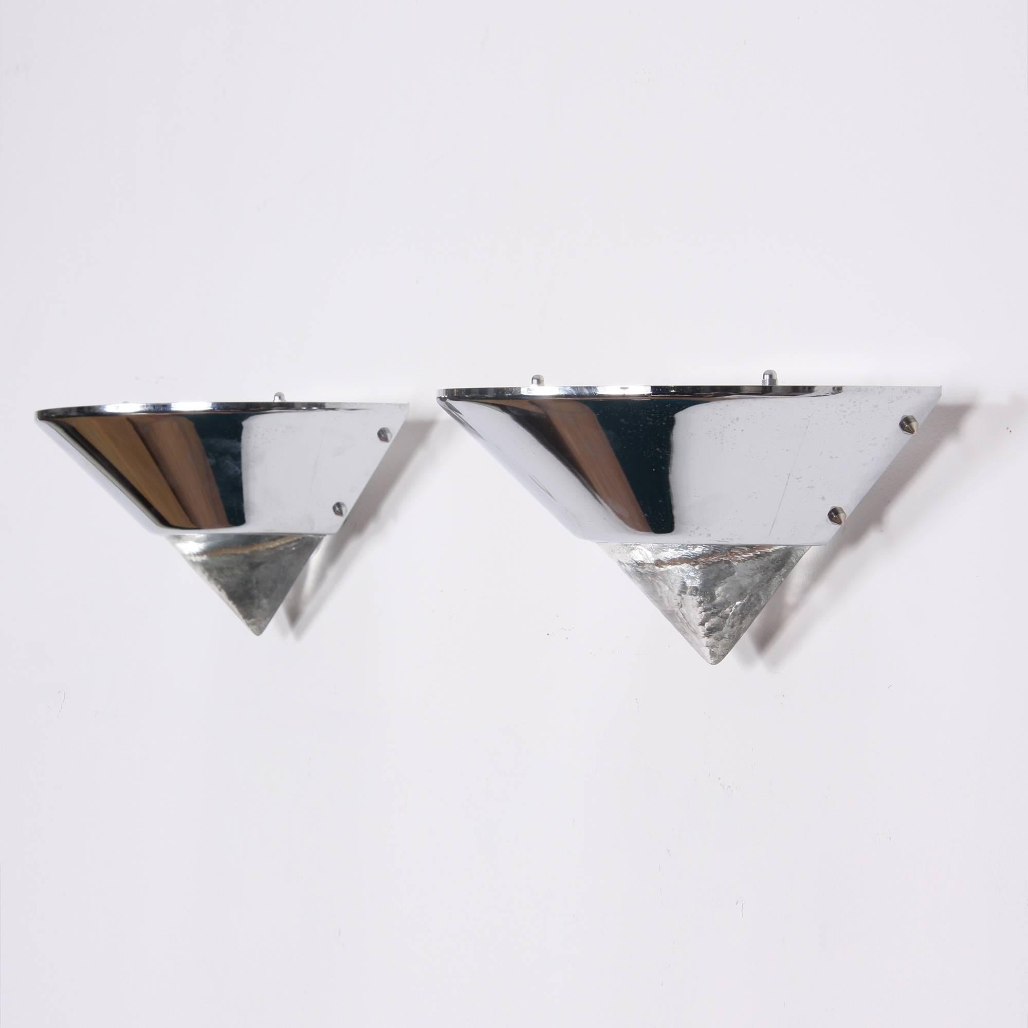 A pair of uplighter wall lights in a triangular shape. Solid glass on the lower part with a chromed metal upper part. Includes re-wiring.
